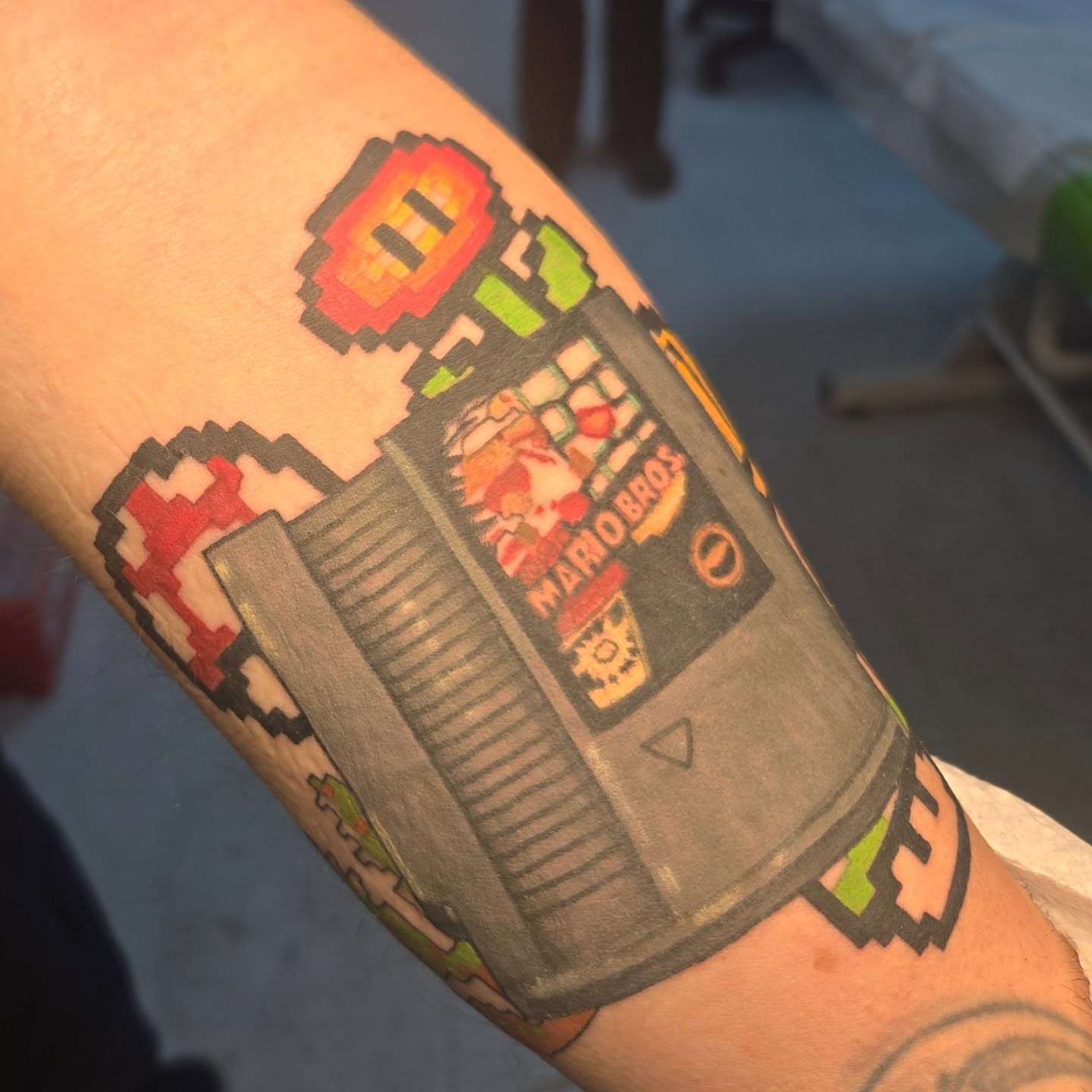 NES console dotwork tattoo on the forearm by Abigail (Bgail) Boyd