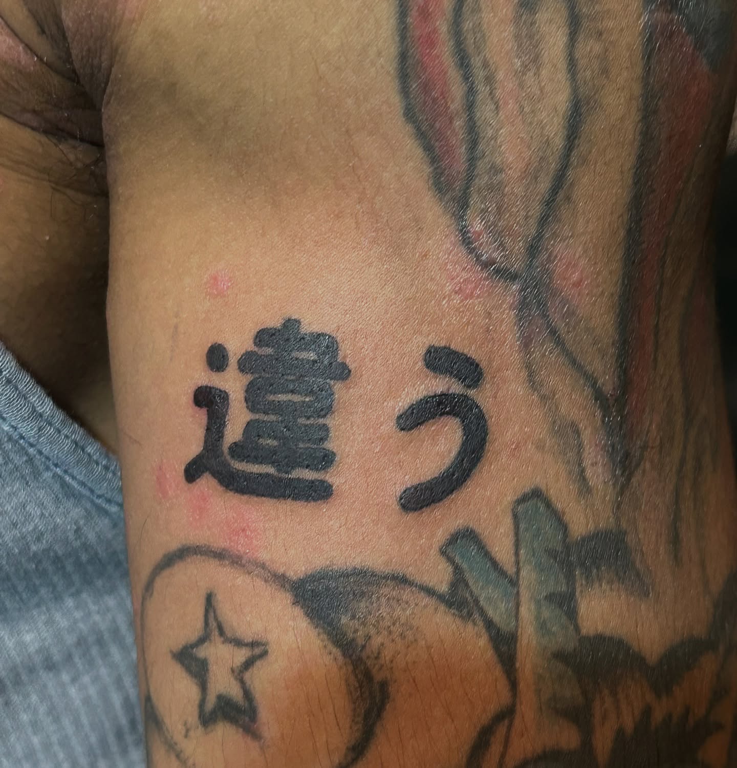 Kanji characters black and grey tattoo on the forearm by Trae