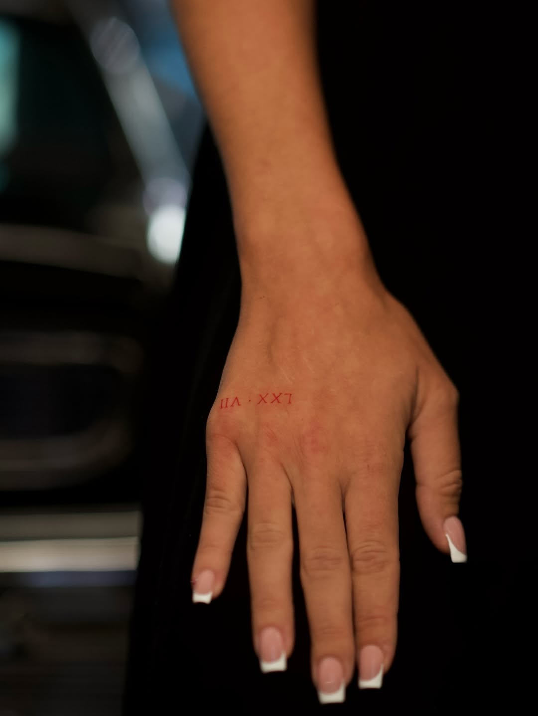Roman numerals lettering tattoo on the hand by @blackastaratattoo