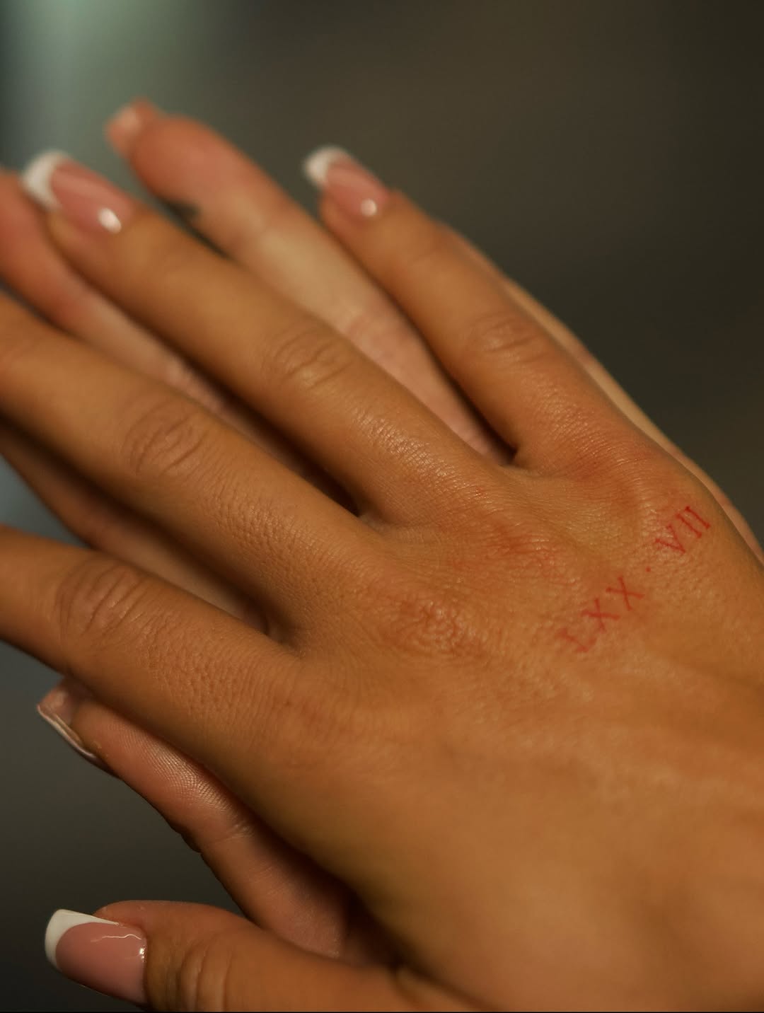 Roman numerals lettering tattoo on the hand by @blackastaratattoo