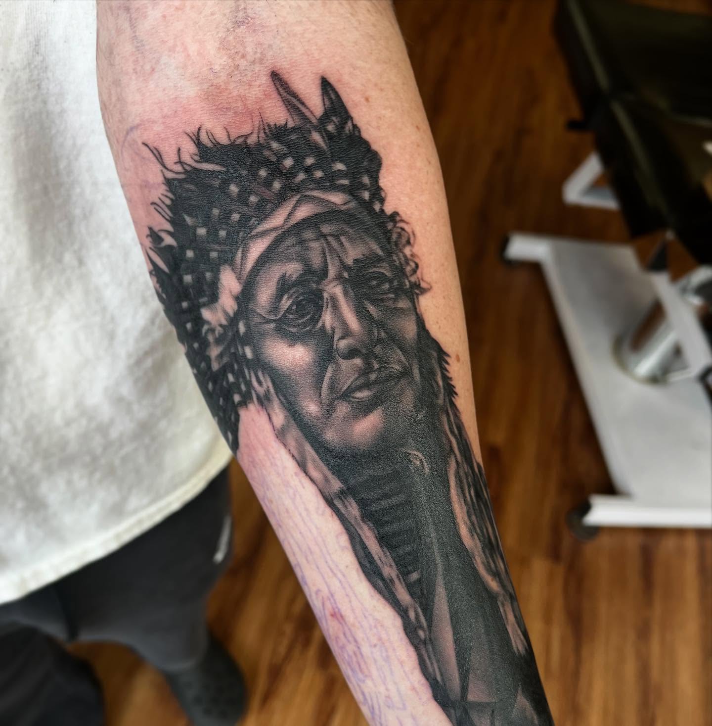 Man with crown realism tattoo on the forearm by Taylor Santavicca
