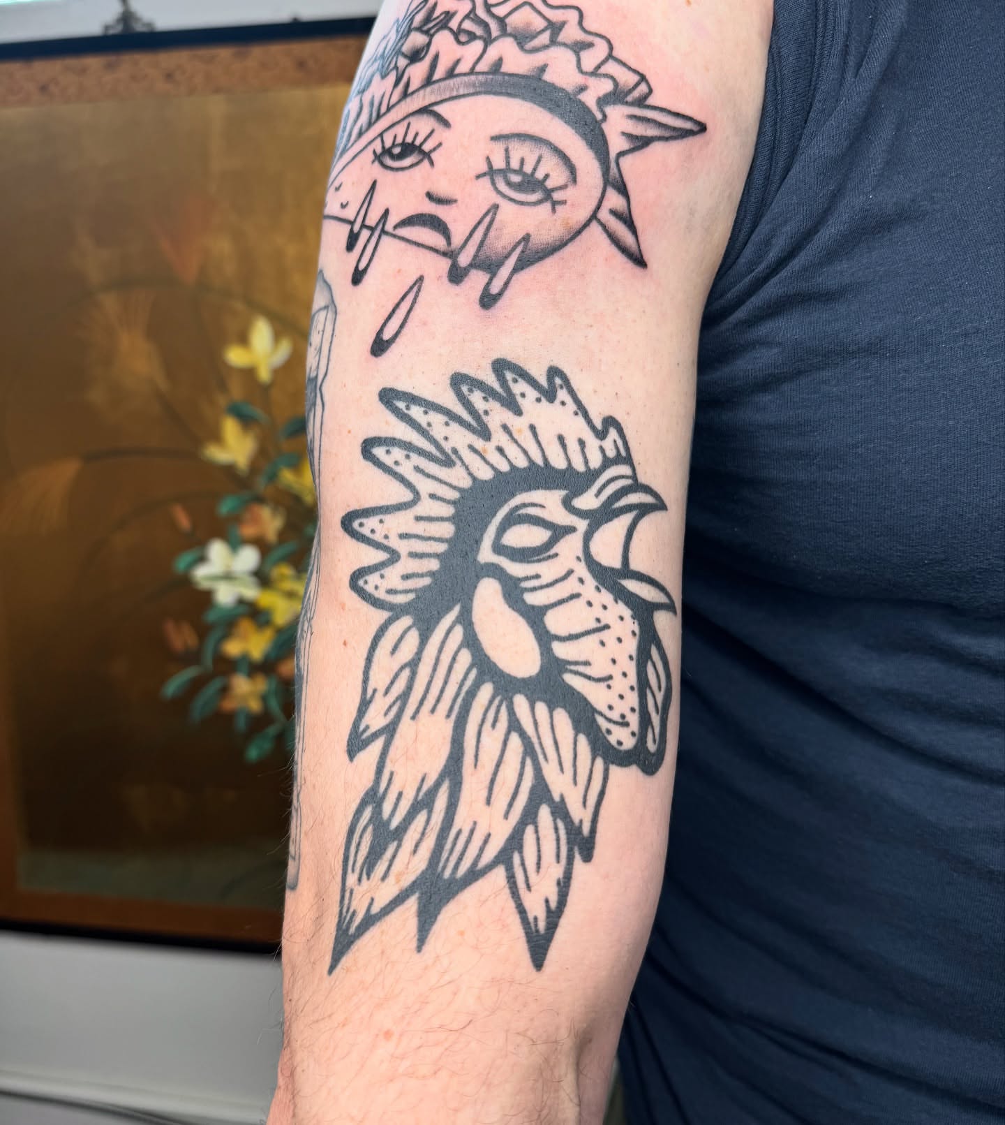 Sun and rooster black and grey tattoo on the forearm by Mazie