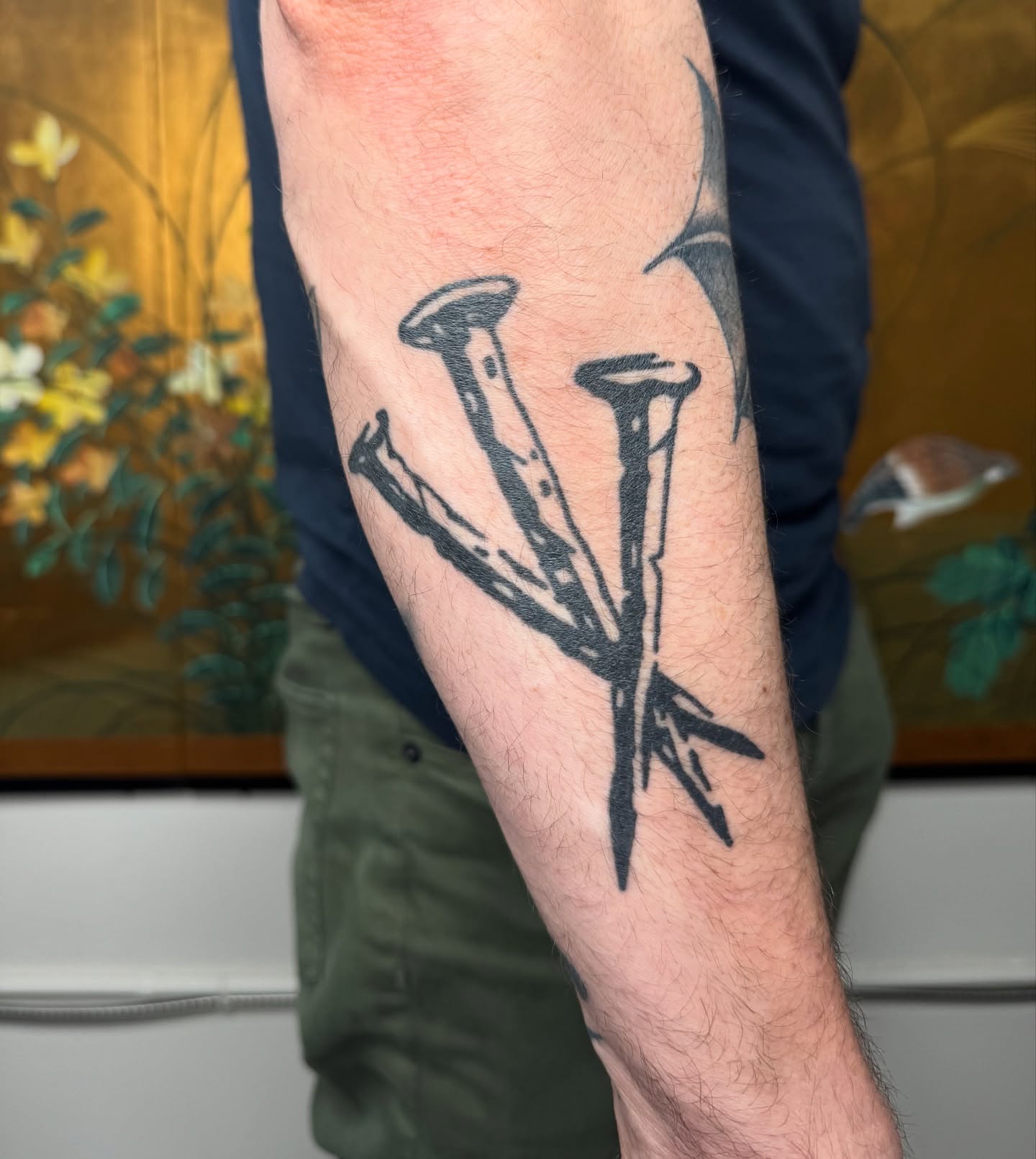 Nails black and grey tattoo on the forearm by Mazie