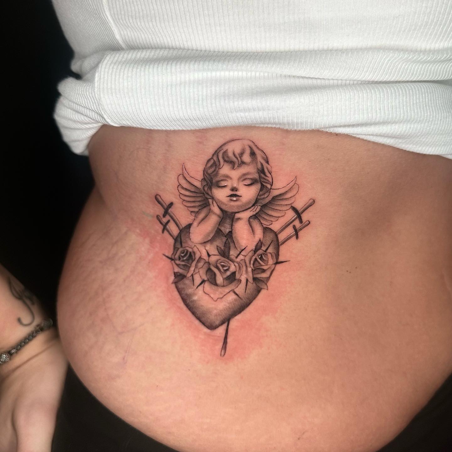 Angel with roses black and grey tattoo on the torso by Angela Azure
