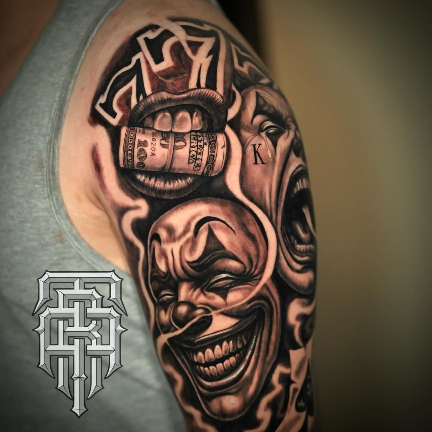Clown face realism tattoo on the upper arm by Art Lopez