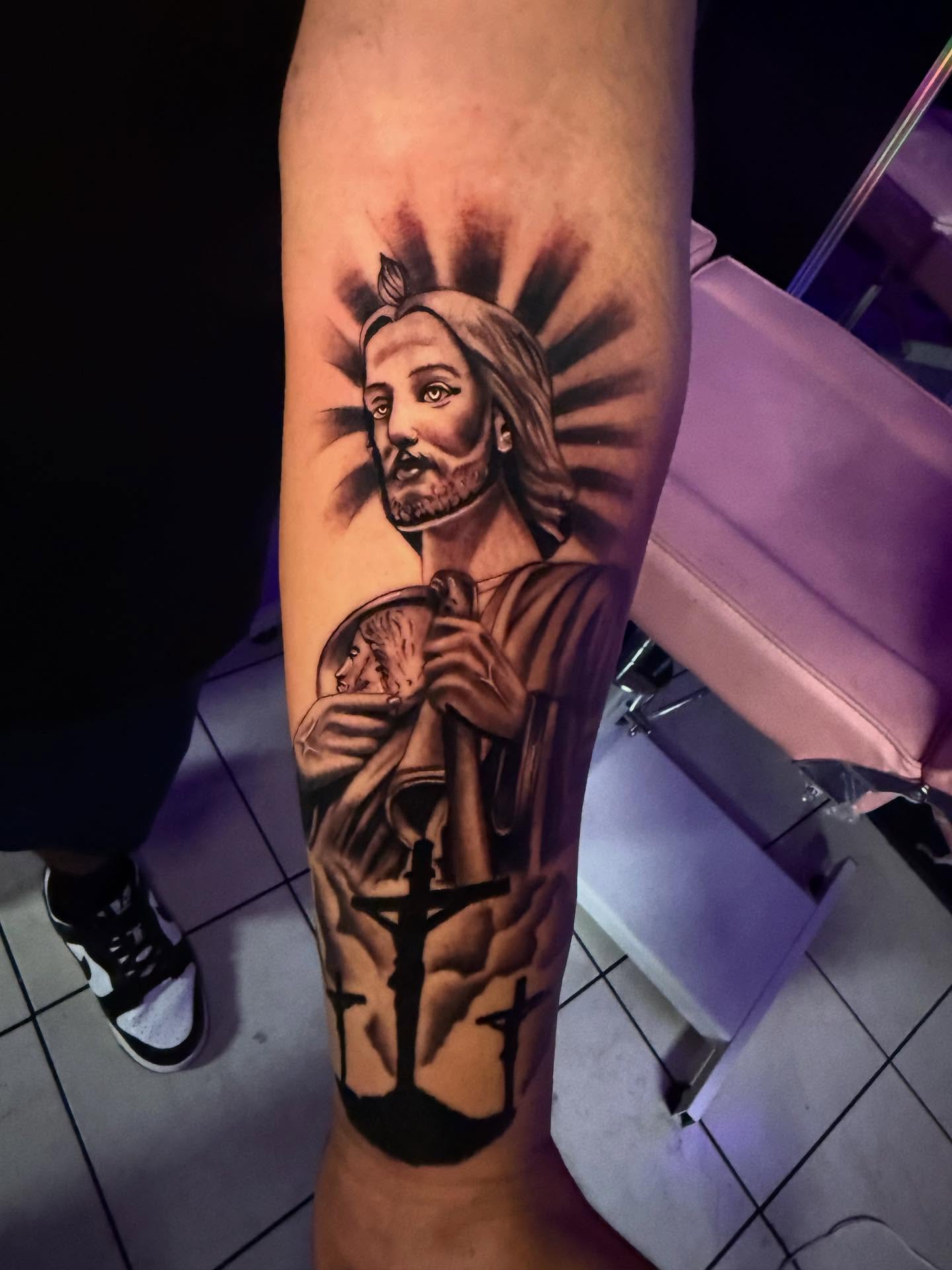 Religious figure black and grey tattoo on the forearm by Jasmin Lozano