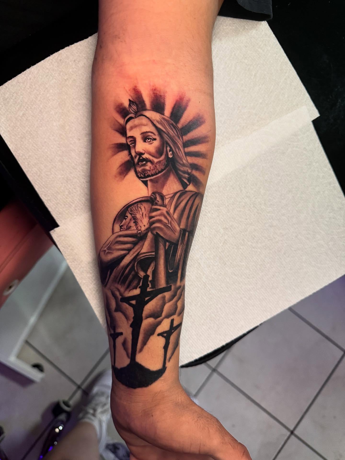 Religious figure black and grey tattoo on the forearm by Jasmin Lozano