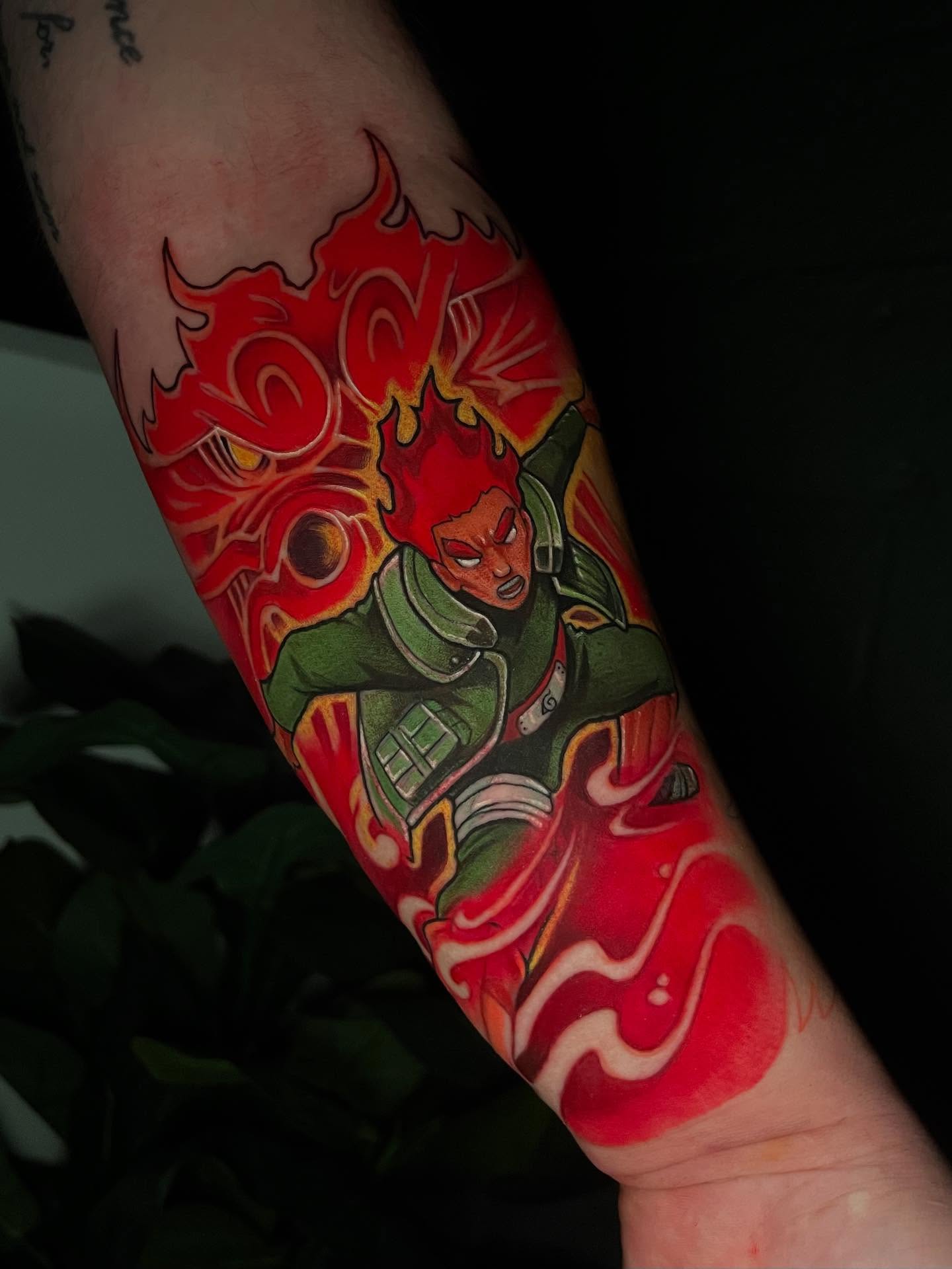 Flame and character anime tattoo on the forearm by emi
