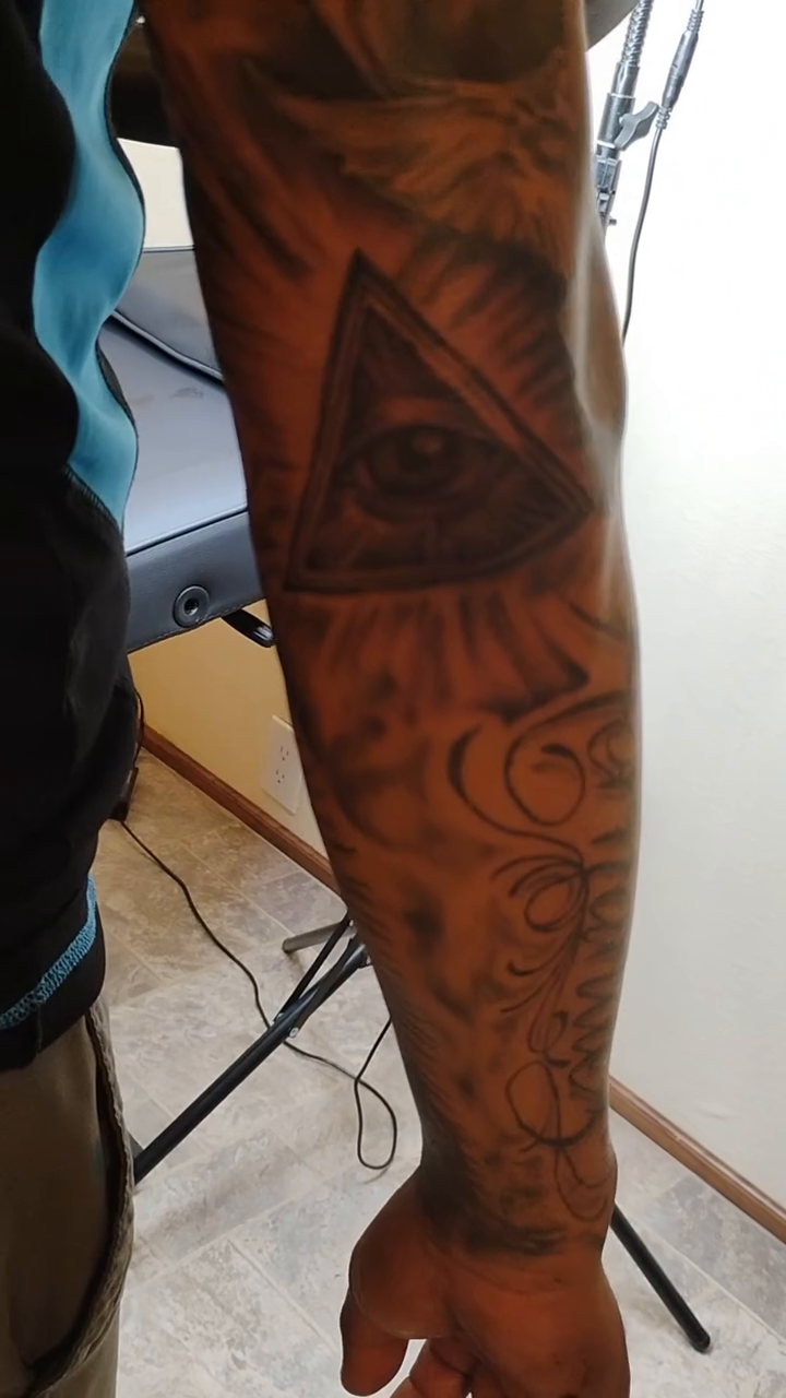 All seeing eye and celestial elements tattoo on the upper arm by Alfredo Sosa