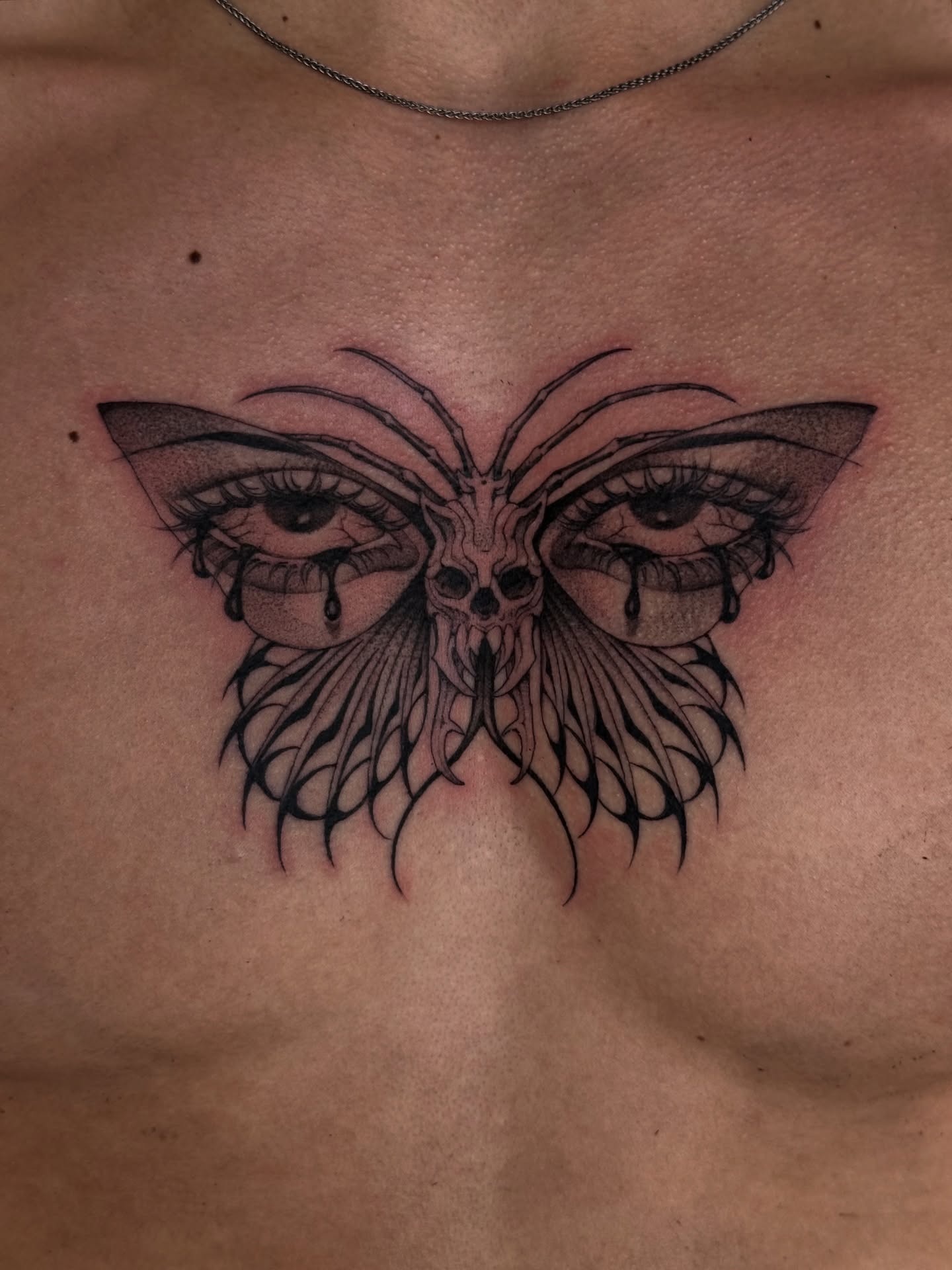 Butterfly eyes dark realism tattoo on the chest by Tattoos.byDahlia, Austin, Texas