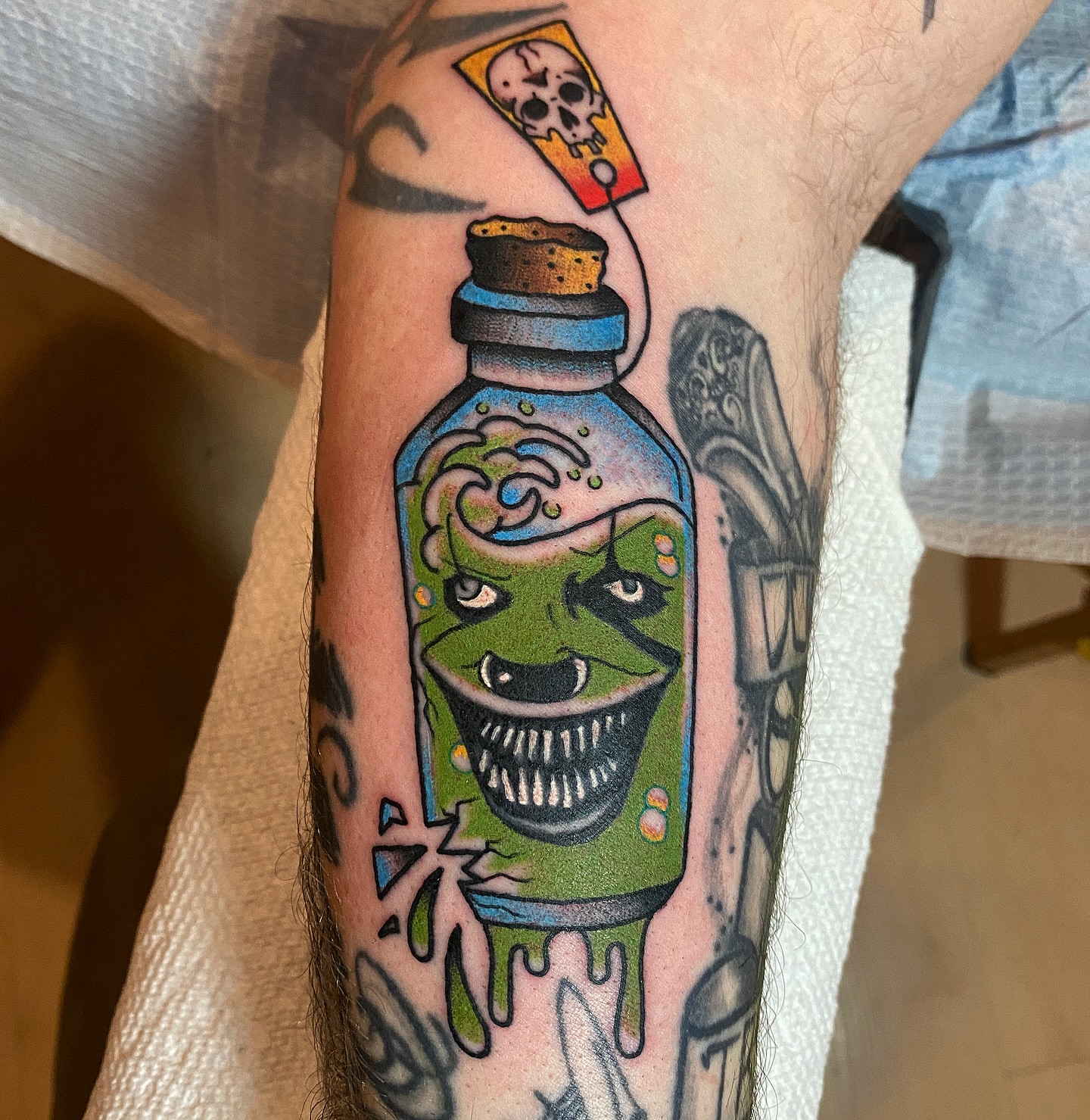Poison bottle trash polka tattoo on the forearm by atomlenhart, Lancaster, Pennsylvania