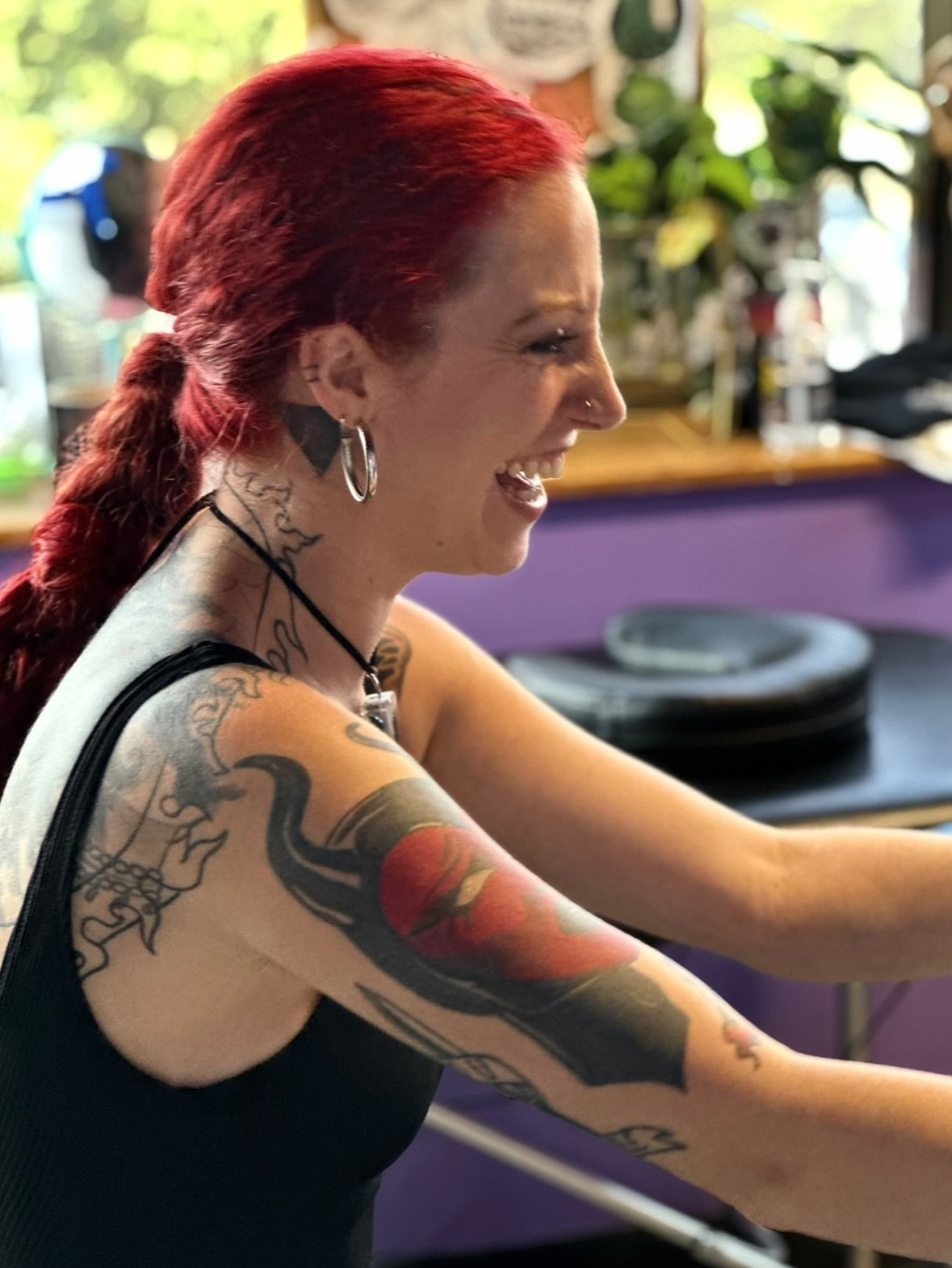 Red rose American traditional tattoo on the upper arm by Nashville Tattoo Artist