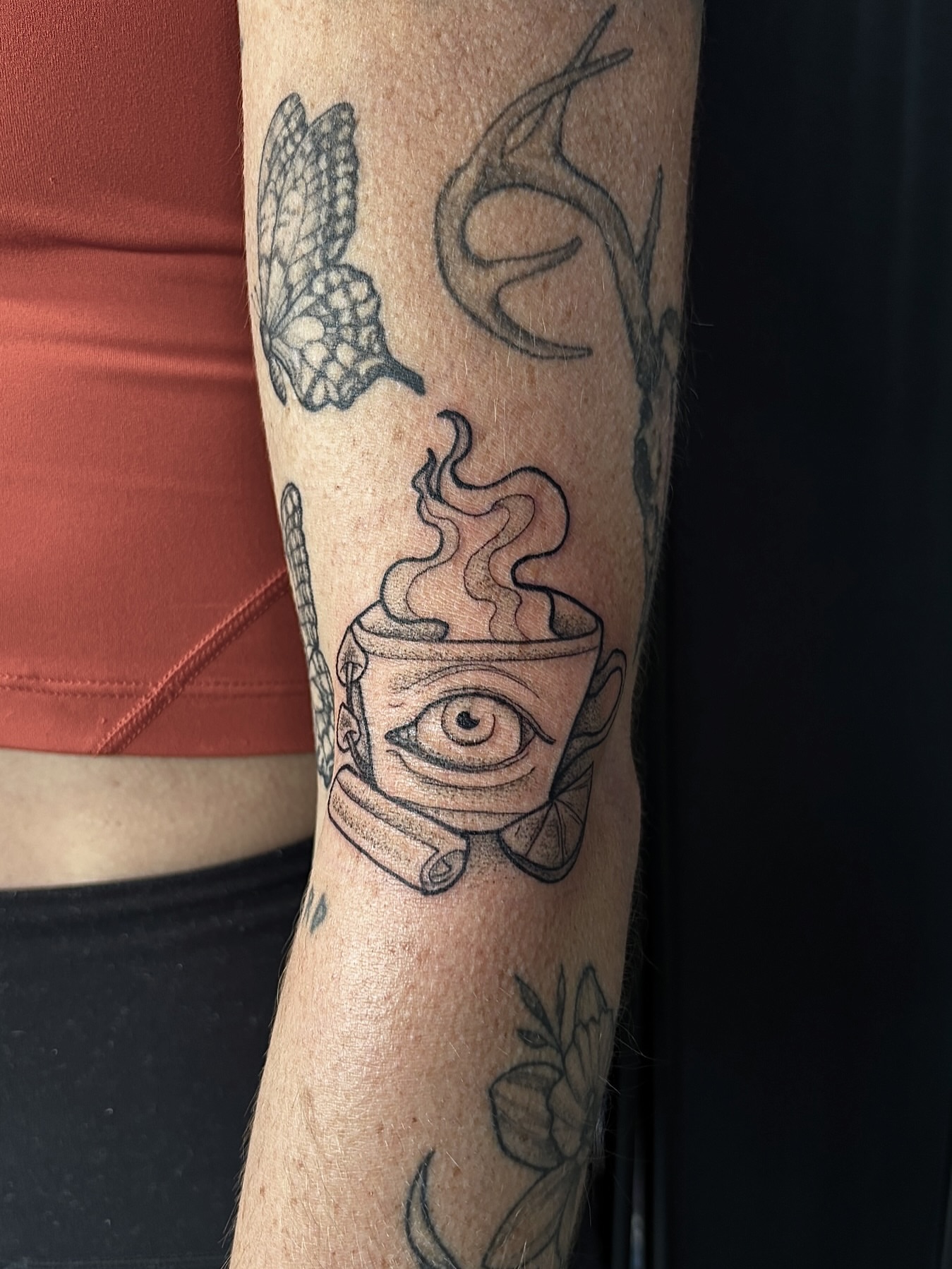 Coffee cup with eye black and grey tattoo on the forearm by Nashville Tattoo Artist