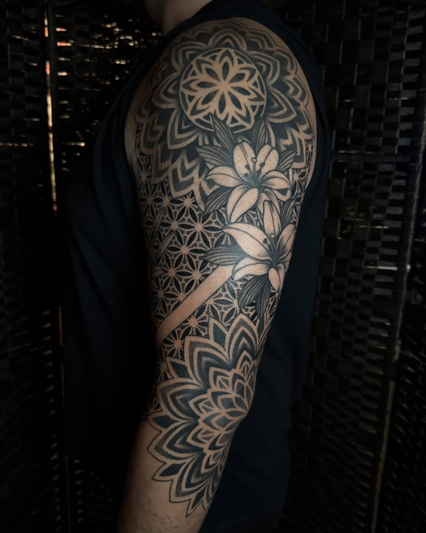 Lily and mandala geometric tattoo on the upper arm by Rose Ulinski