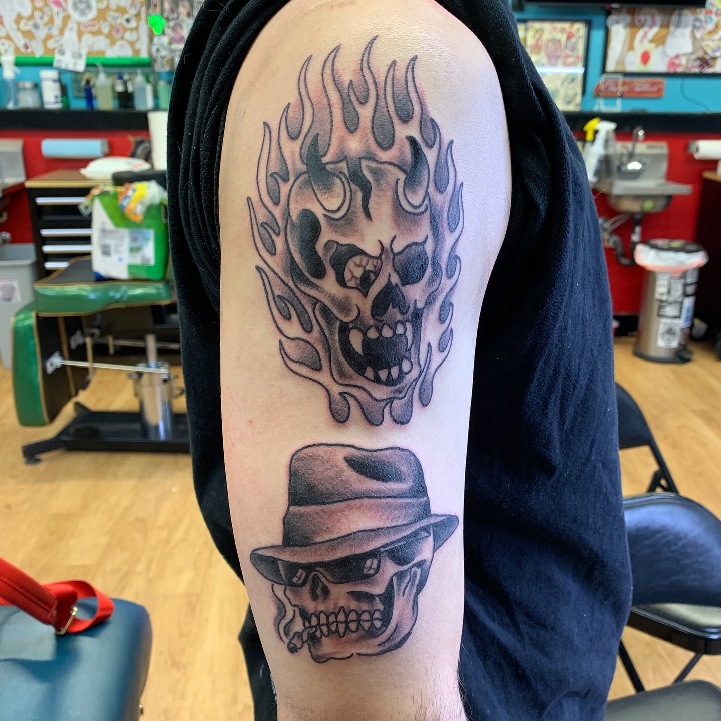 Flaming skull wearing hat realism tattoo on the forearm by Tattoos Las Vegas,NV
