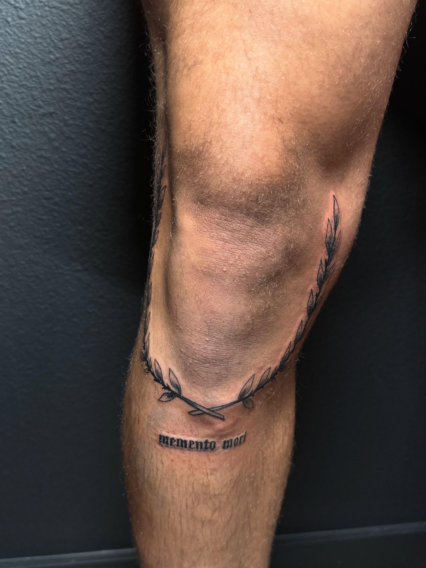 Wreath black and grey tattoo on the calf by Elian Sanchez Austin Tx. Tattoo Artist