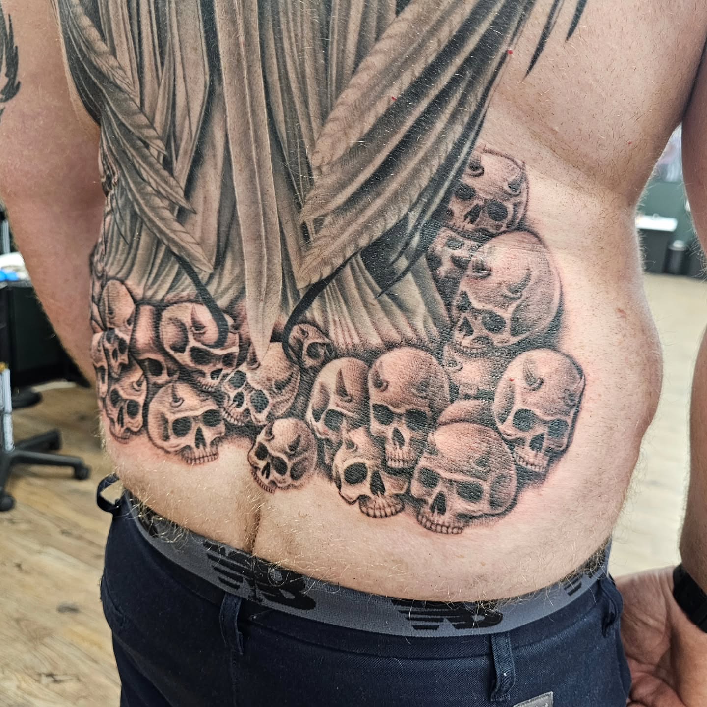 Skulls realism tattoo on the torso by Derek Davis