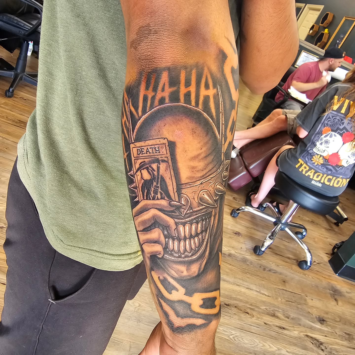 Grinning skull realism tattoo on the forearm by Derek Davis
