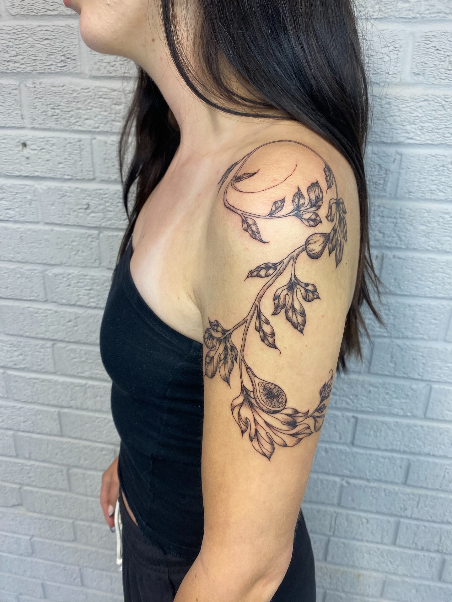 Floral vine black and grey tattoo on the shoulder by Ellena Reggiani