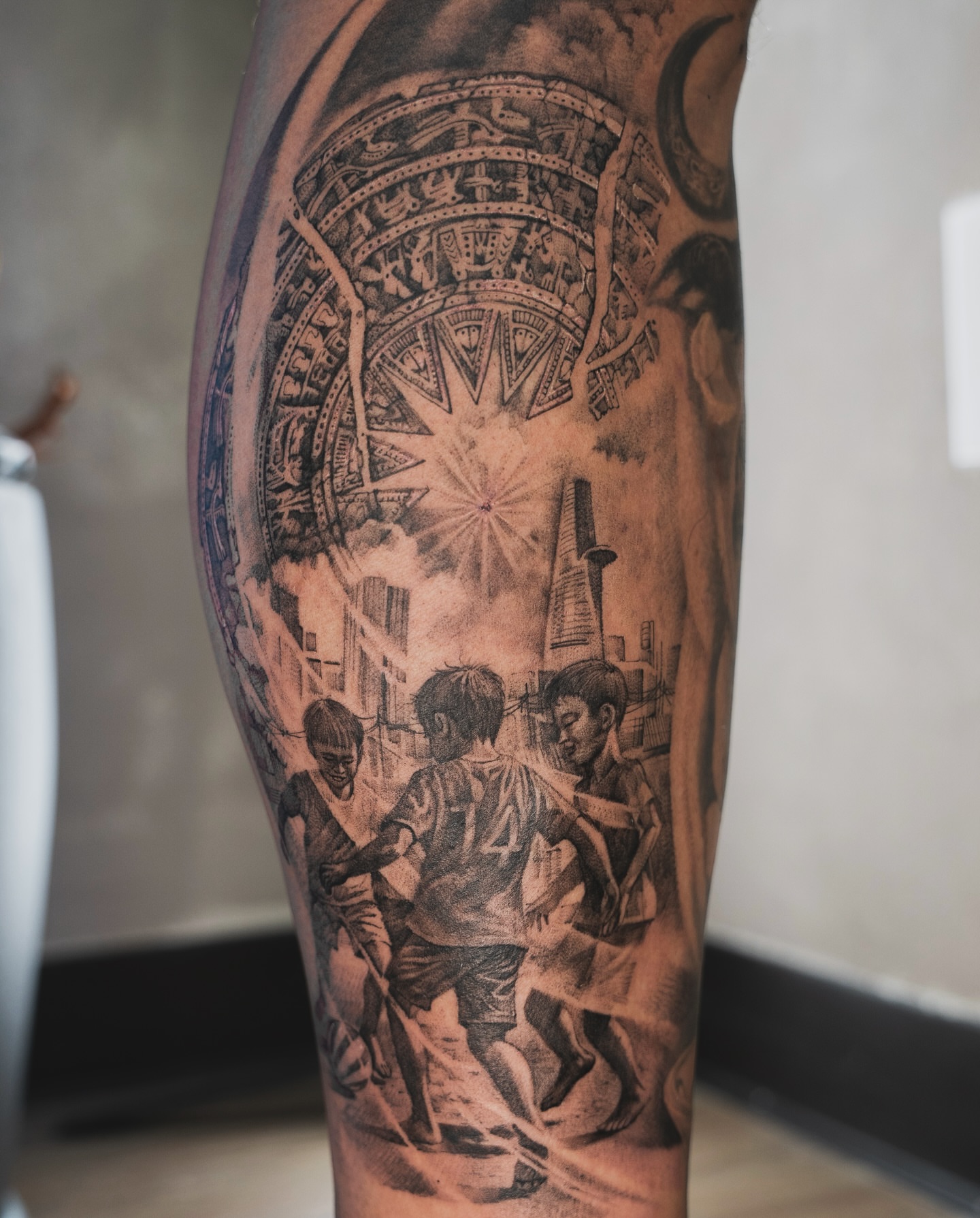 Street scene with children playing realism tattoo on the forearm by Tri