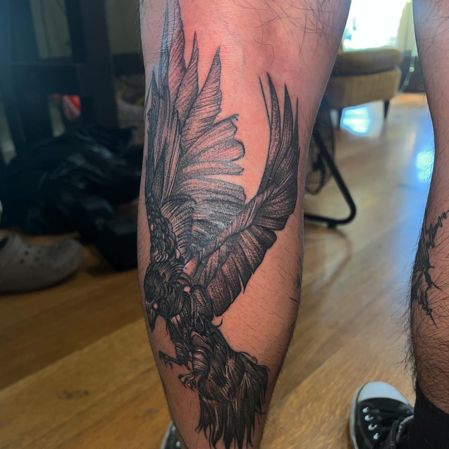 Bird black and grey tattoo on the calf by zion