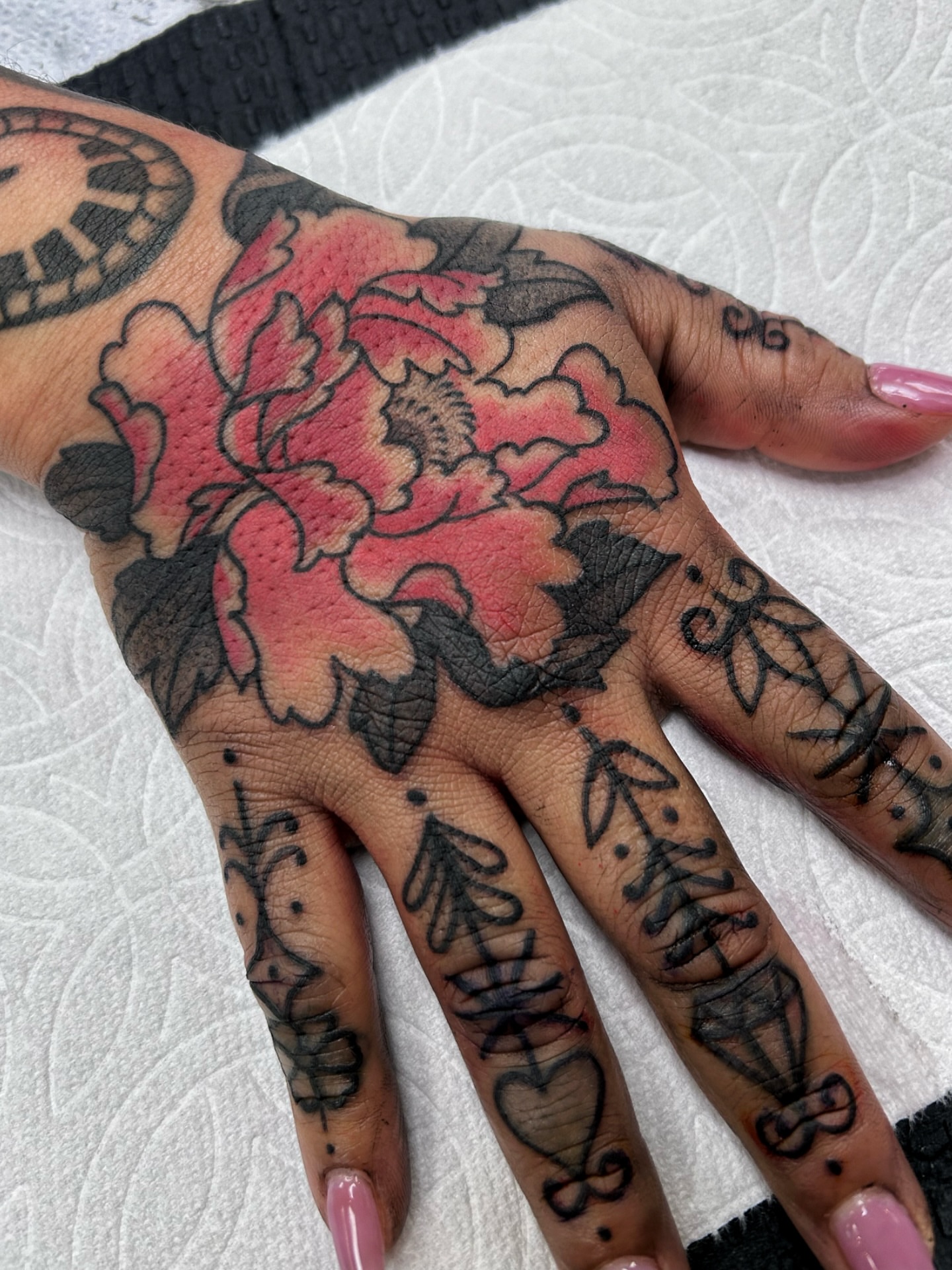 Peony American traditional tattoo on the hand by Jade McKenzie, Temecula, California