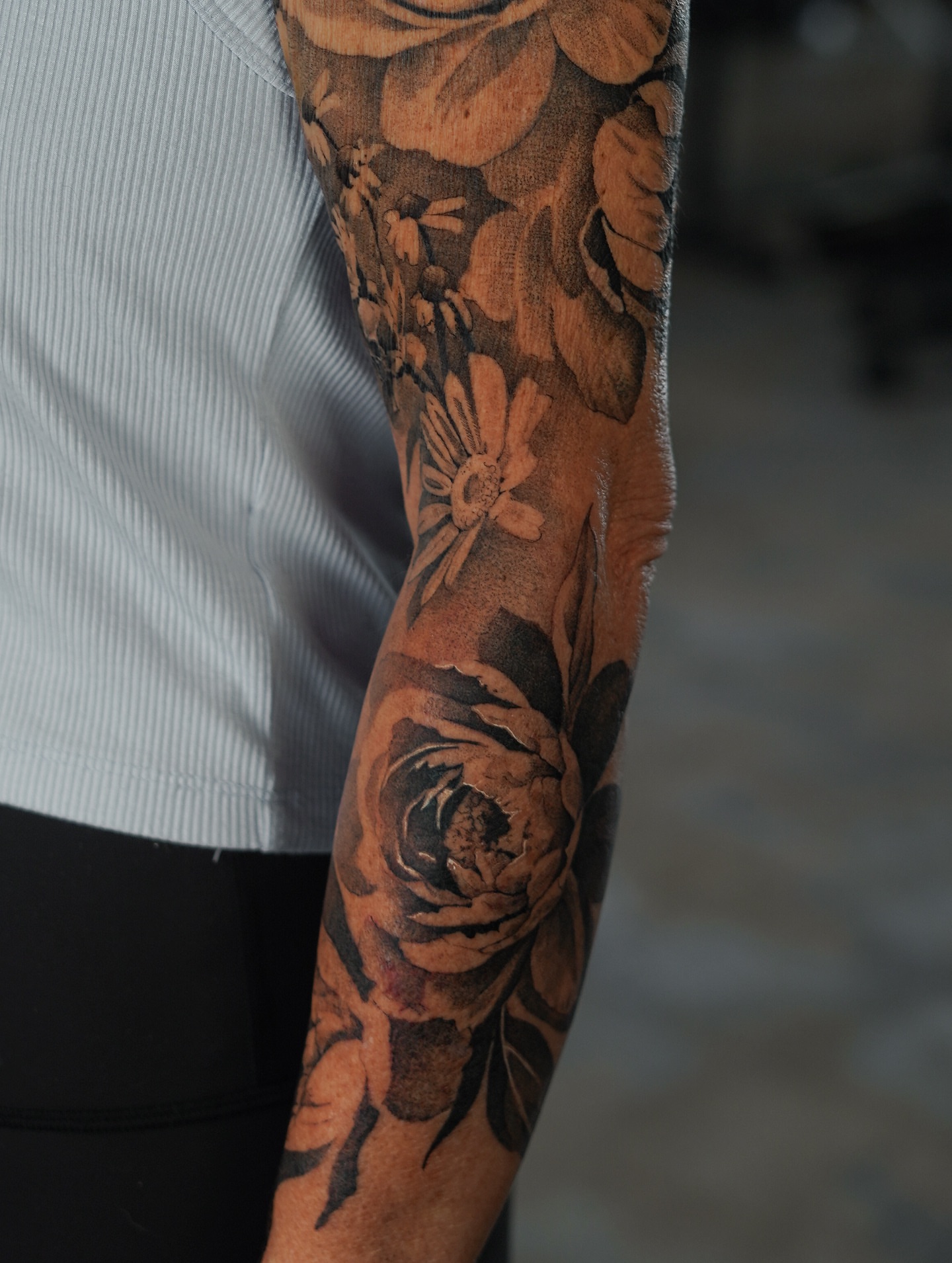 Floral bouquet realism tattoo on the forearm by Keely Thompson