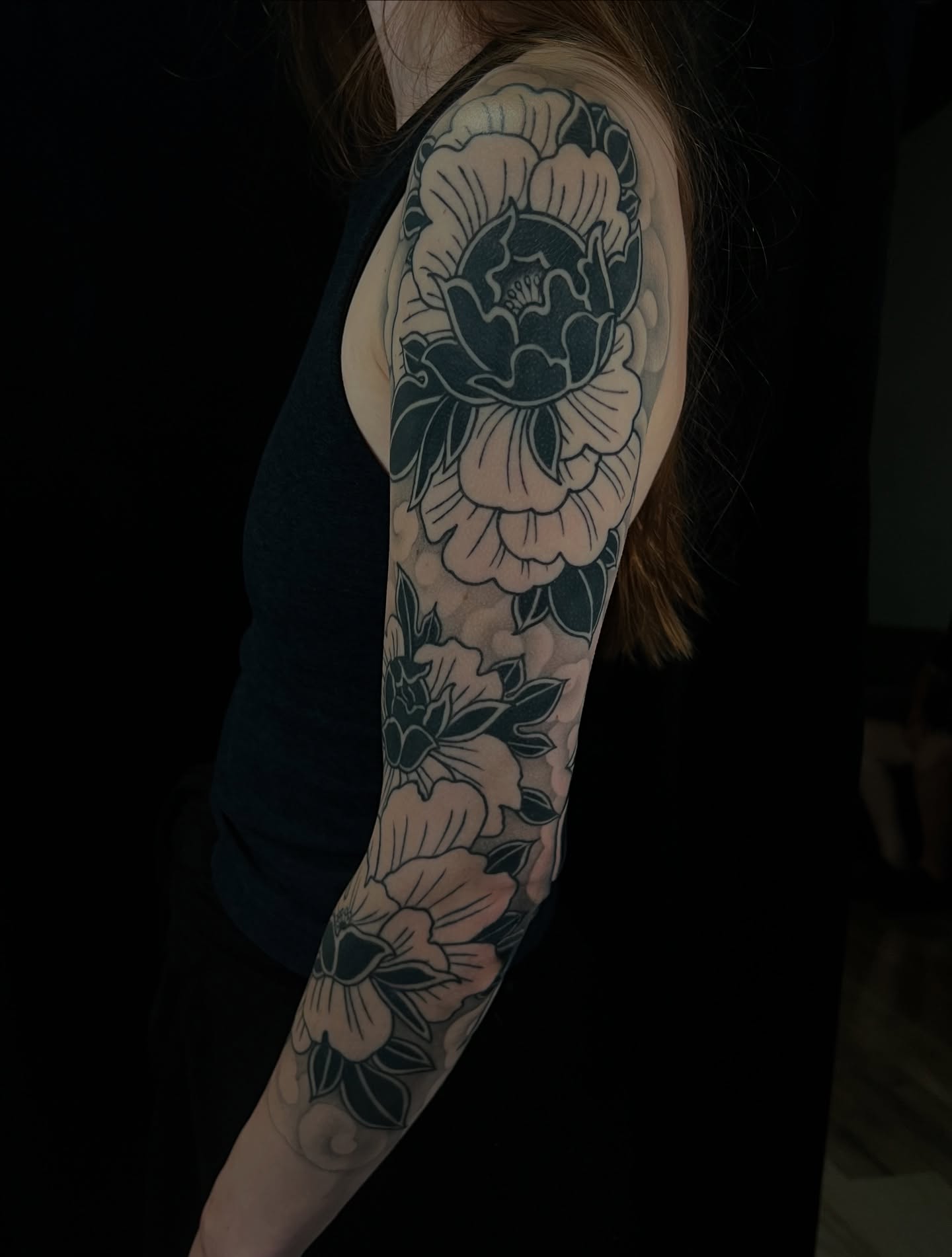 Floral bouquet black and grey tattoo on the upper arm by Pam Sanders