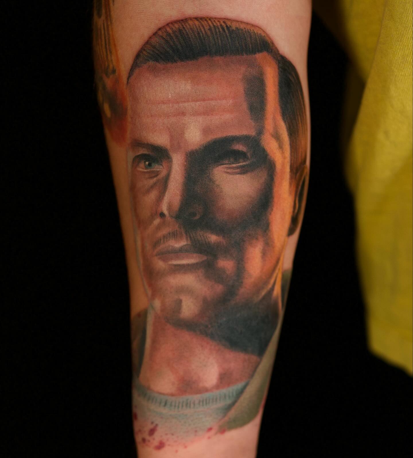 Portrait realism tattoo on the forearm by Chris Lochbihler