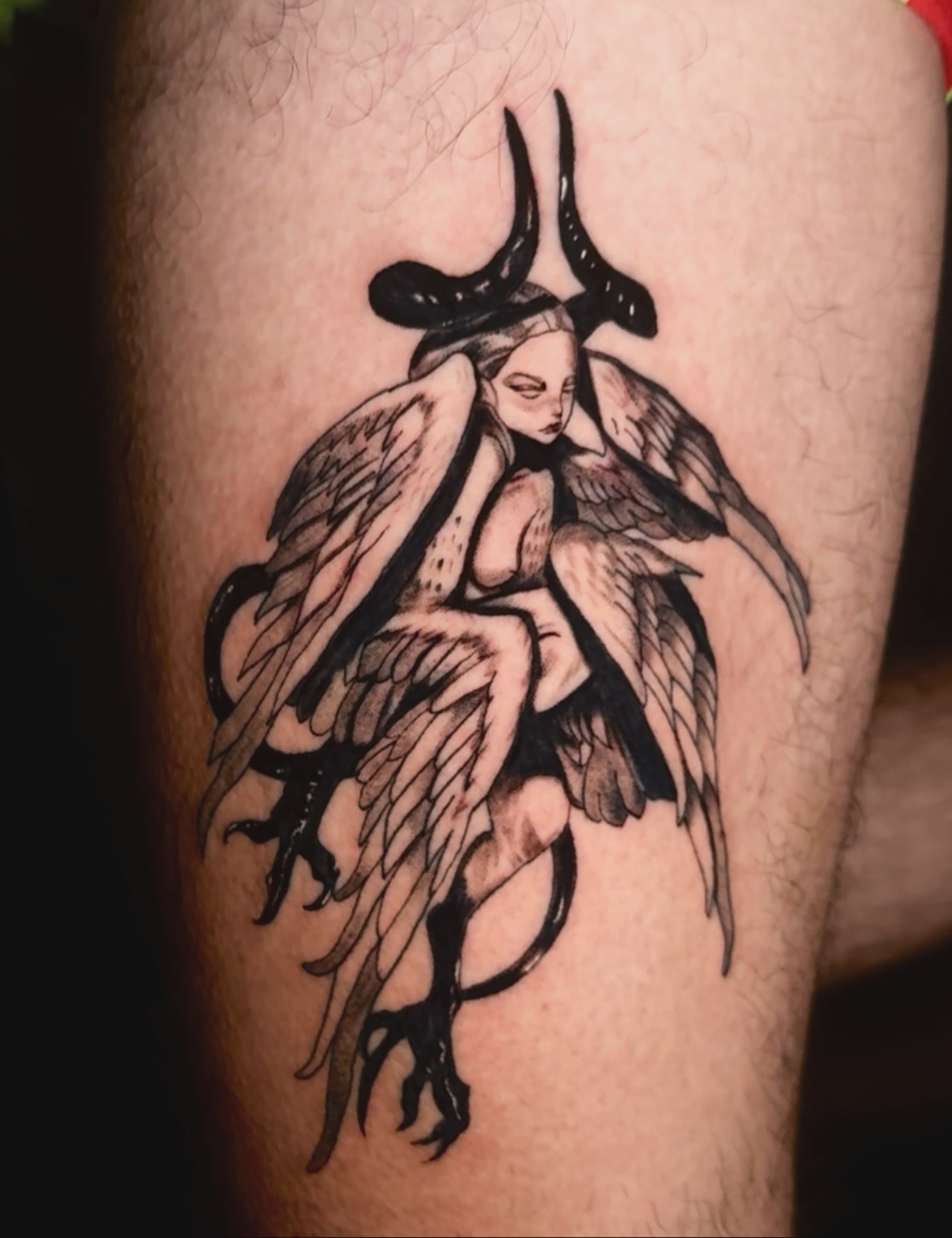 Angel with horns black and grey tattoo on the forearm by V
