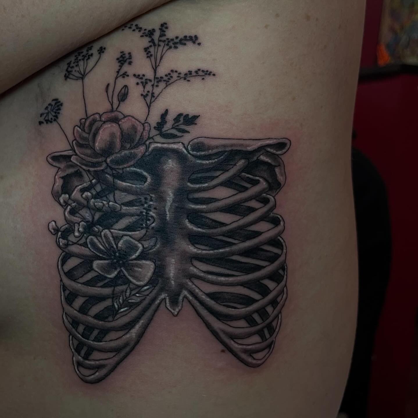 Rib cage with flowers black and grey tattoo on the ribs by Chrissy Ungrew Tattoos, Covington, Kentucky