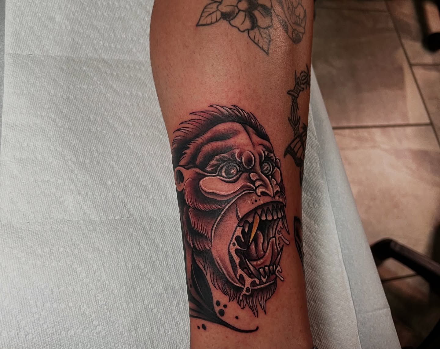 Angry face realism tattoo on the forearm by BodyArtByAlia