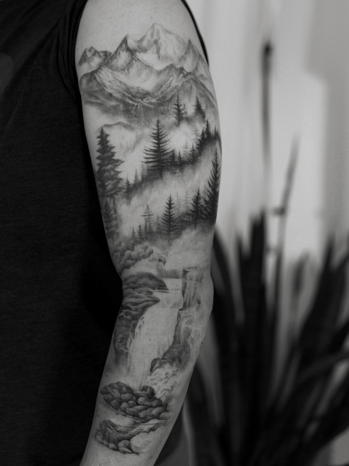 Mountain landscape realism tattoo on the forearm by Ray Quinday