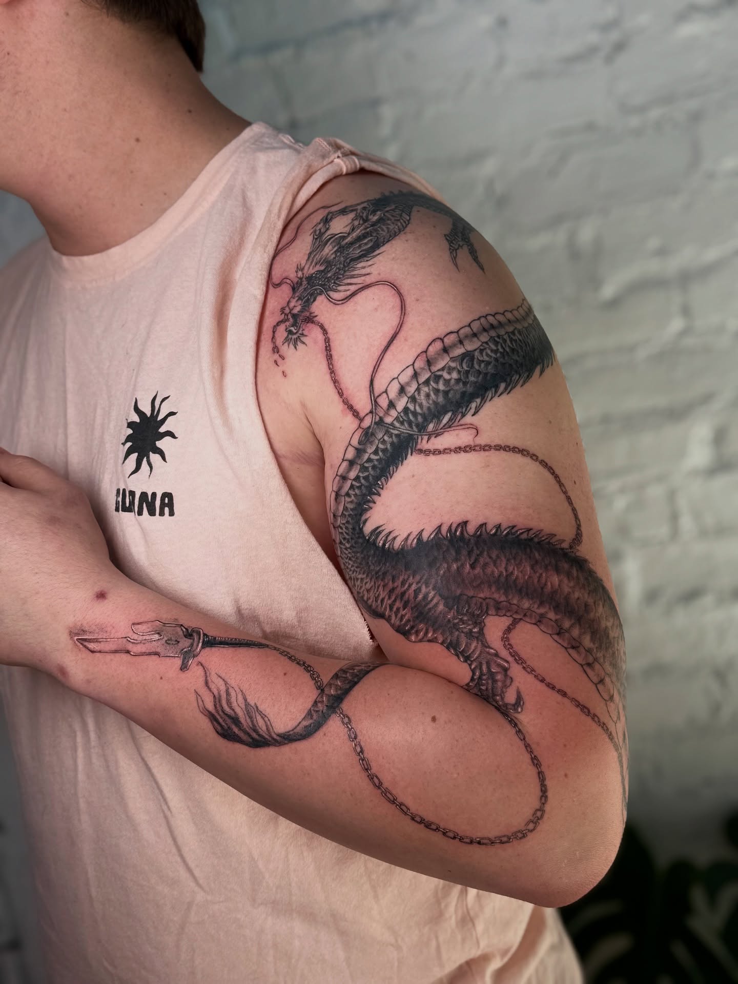 Dragon black and grey tattoo on the upper arm by Asia Rene Tattoos👑