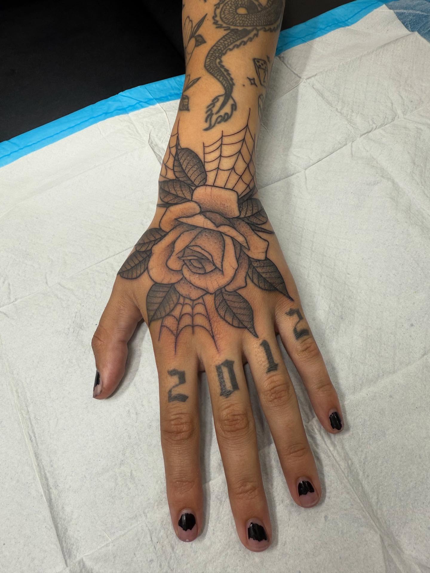 Rose American traditional tattoo on the hand by Maddie Jo DeYoung