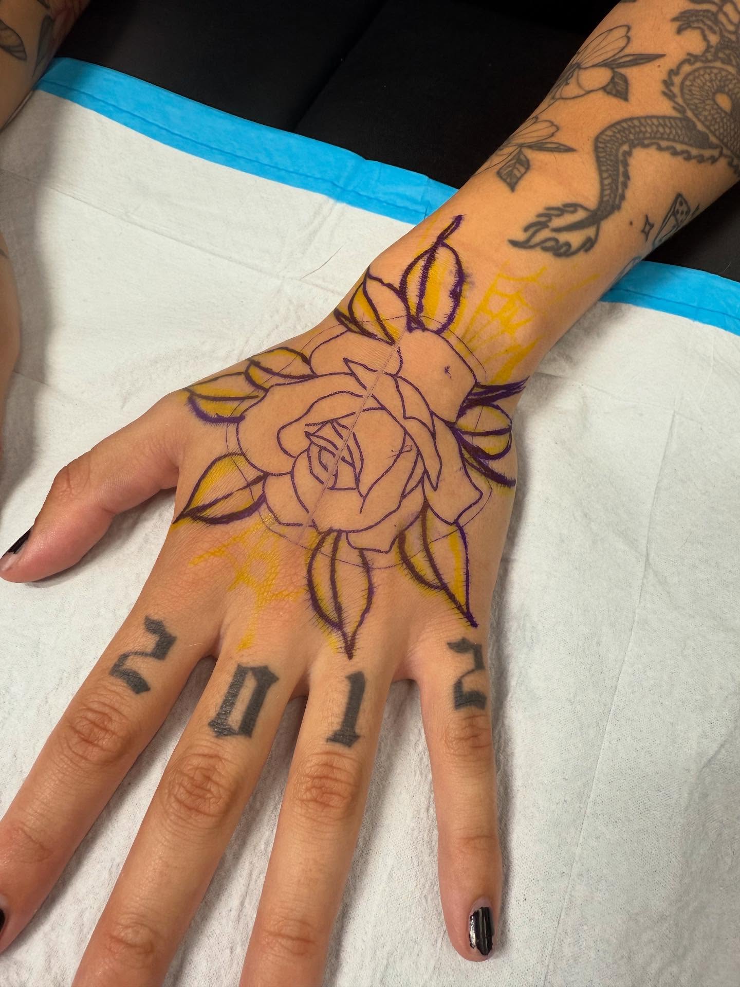 Rose American traditional tattoo on the hand by Maddie Jo DeYoung