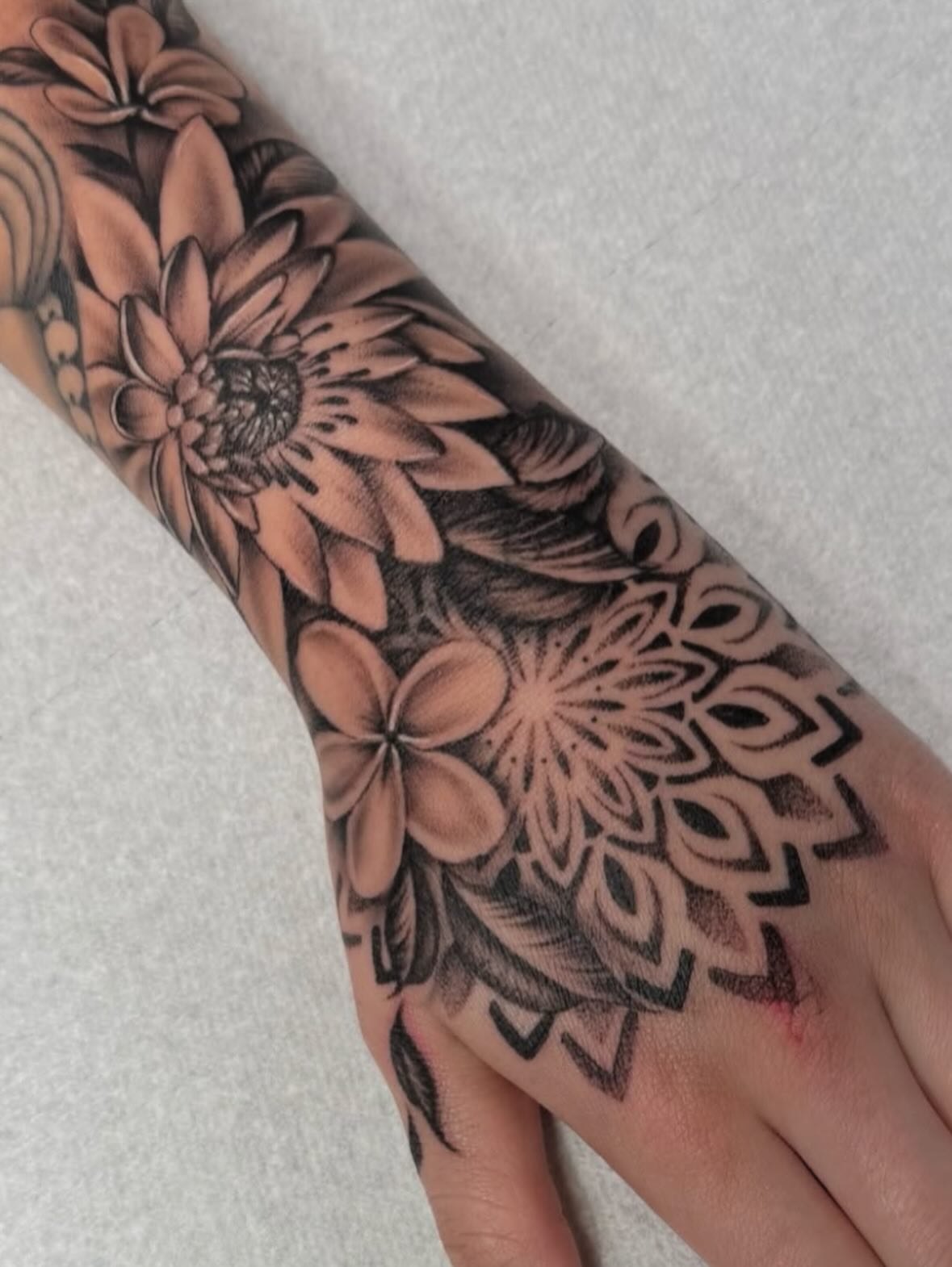 Floral mandala geometric tattoo on the forearm by Grace P
