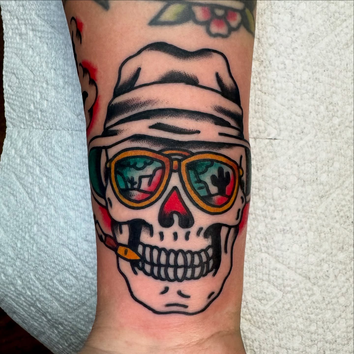 Skull wearing sunglasses American traditional tattoo on the forearm by Buddy (Holiday) Orr, Las Vegas, Nevada