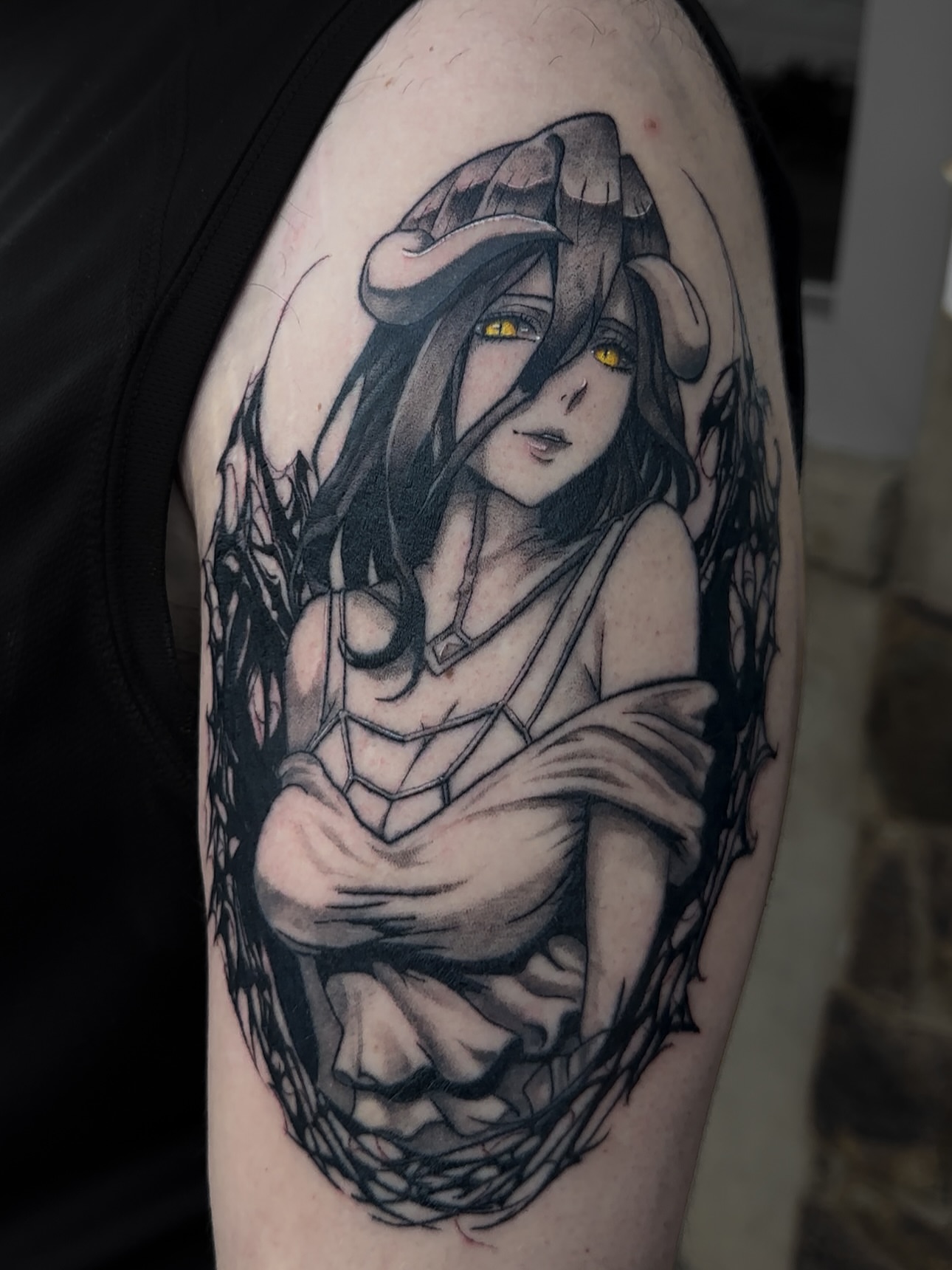 Woman with hat black and grey tattoo on the upper arm by Sincere