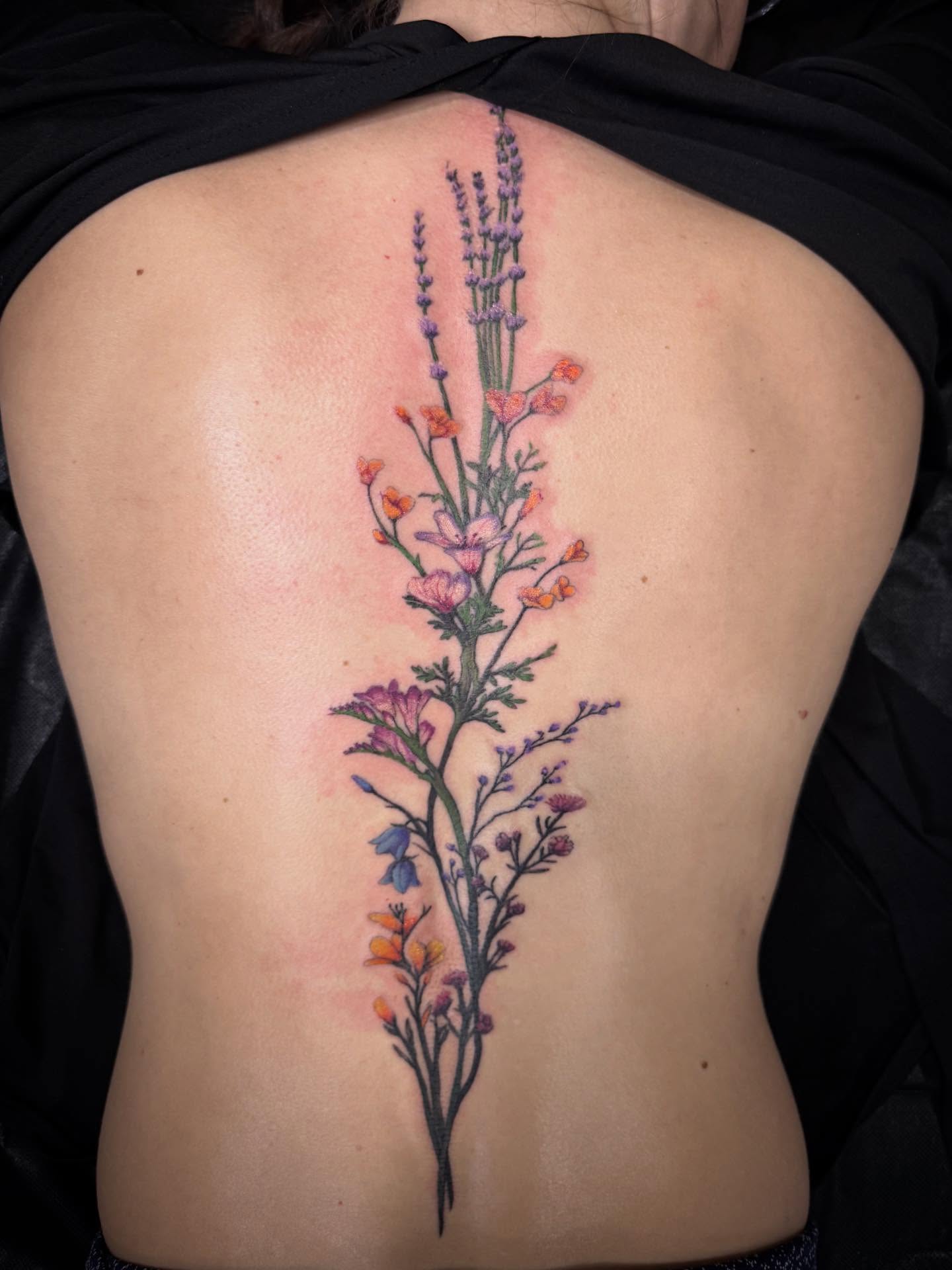 Flower bouquet watercolor tattoo on the back by Brennan Walker, Orem, Utah