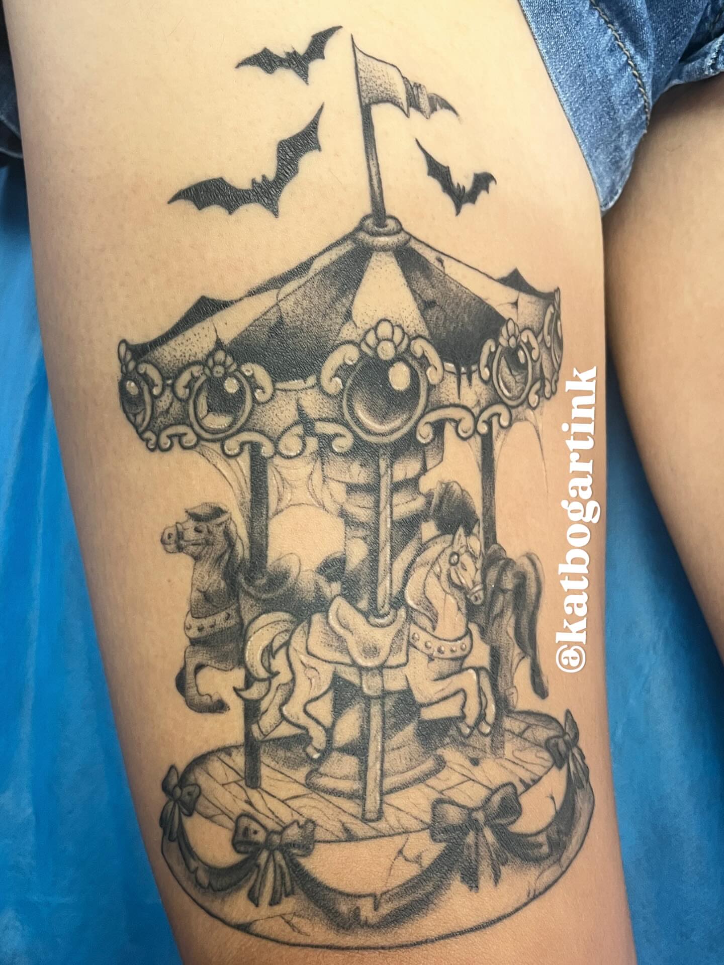 Carousel black and grey tattoo on the thigh by Kat (Scout) Bogart