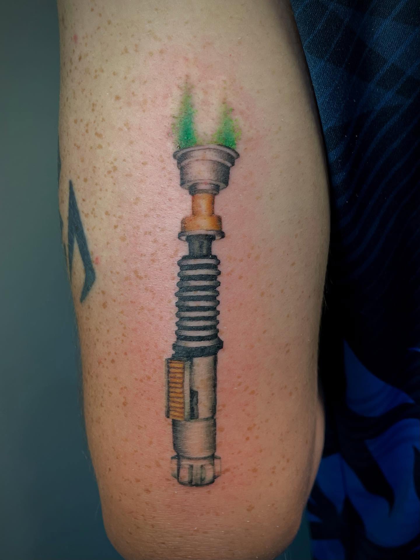 Lightsaber realism tattoo on the forearm by Bryce Presley, Mission, Kansas