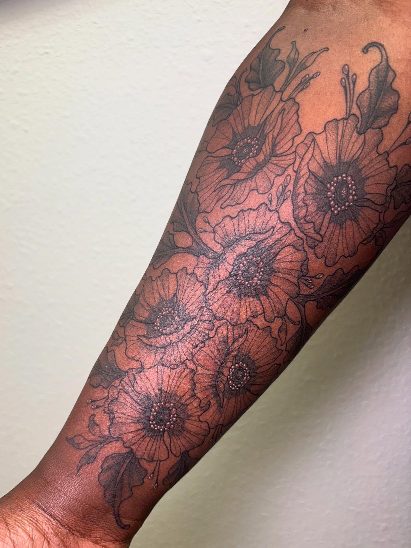 Poppy flowers black and grey tattoo on the forearm by Rachel Foster