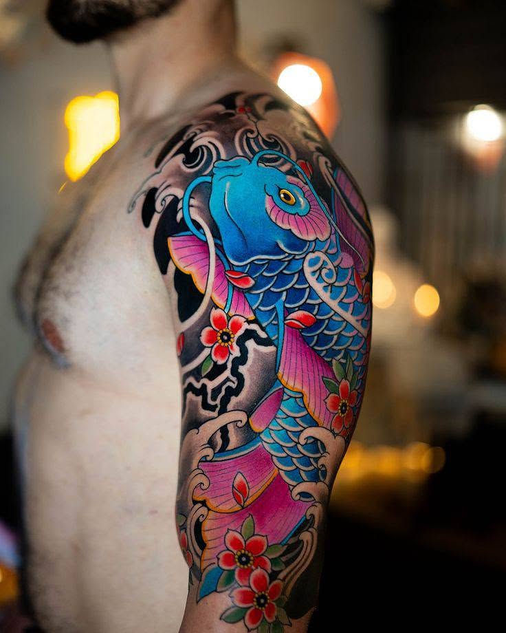 Koi fish and flowers japanese irezumi tattoo on the upper arm by Peter John
