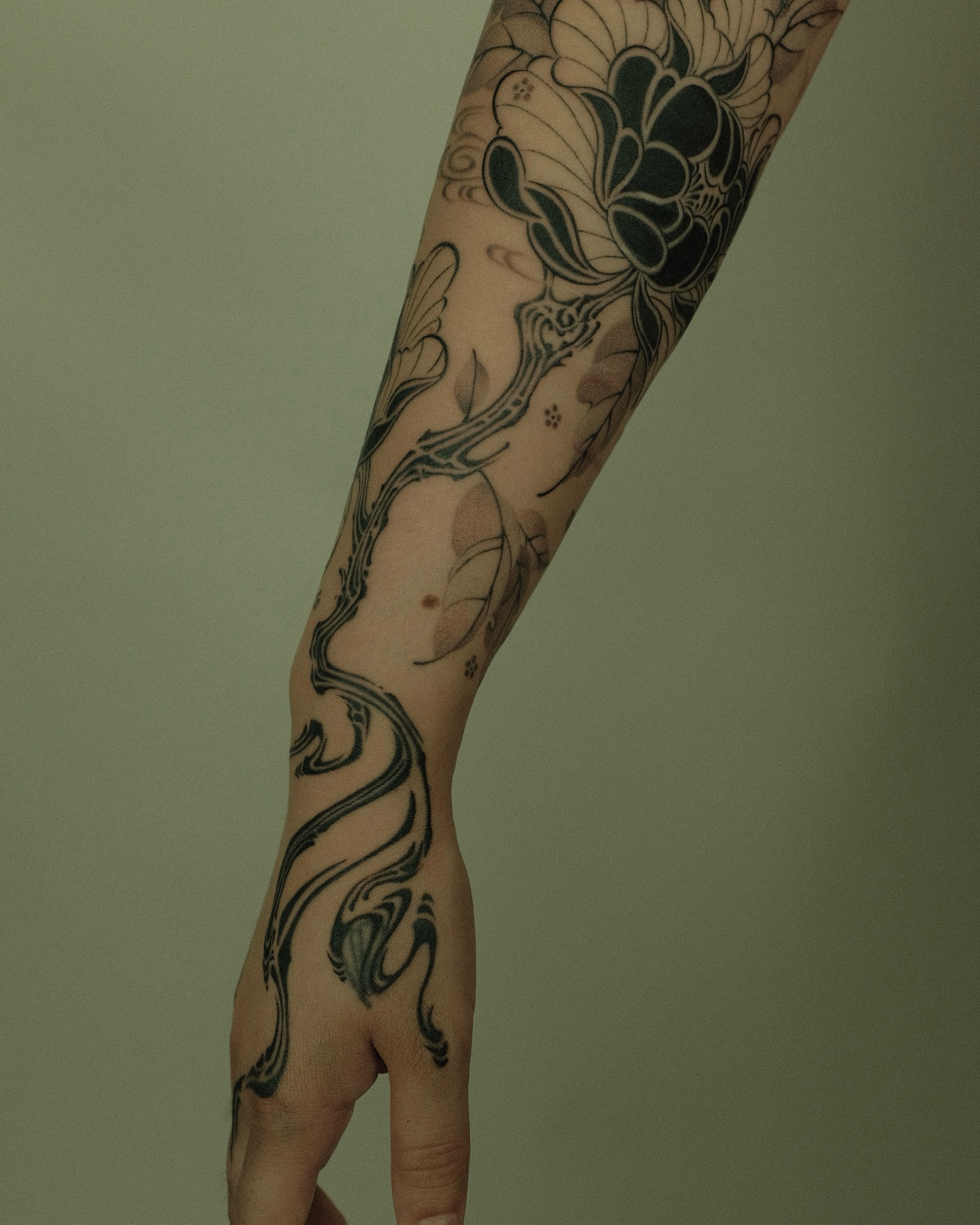 Floral vine black and grey tattoo on the forearm by Xiao Lun