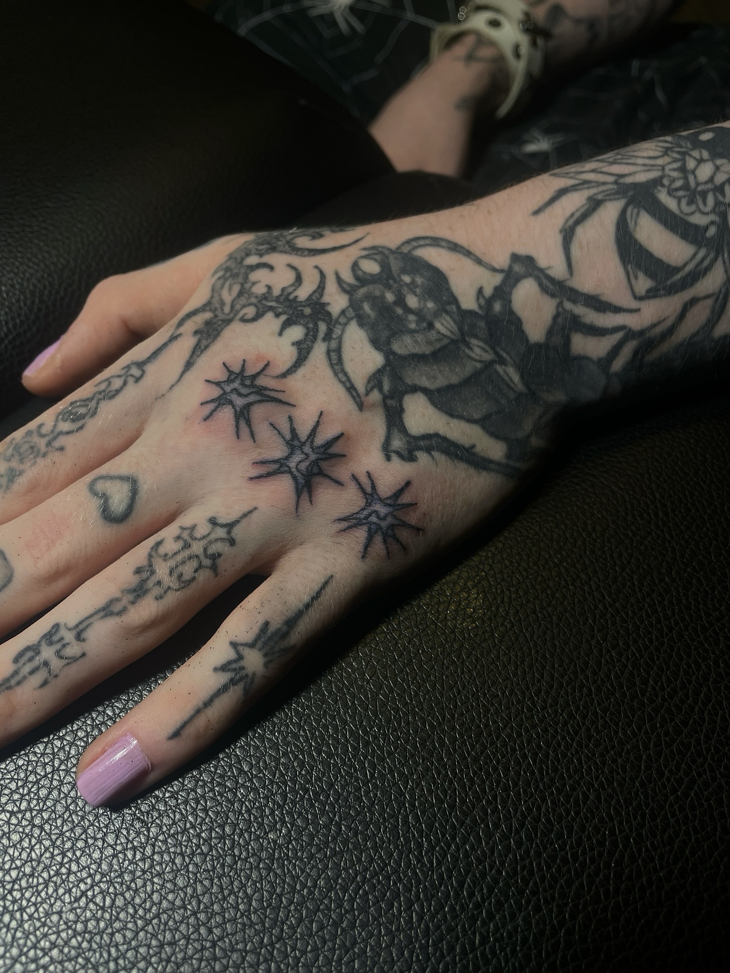 Astronaut and stars black and grey tattoo on the hand by ɴᴏᴍᴢ ᴅʏsᴇᴍʙᴏᴅɪᴍᴇɴᴛ