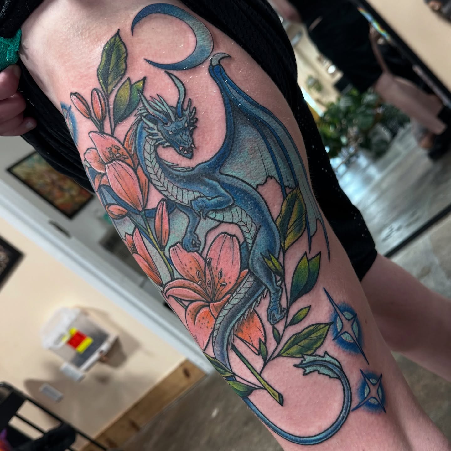 Dragon and flowers American traditional tattoo on the forearm by Emily K Lingg