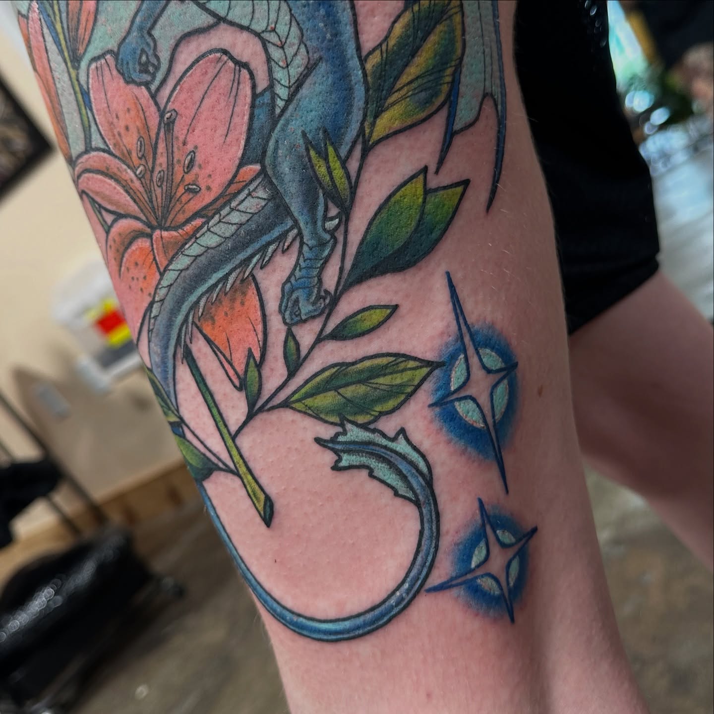 Dragon and lily American traditional tattoo on the forearm by Emily K Lingg