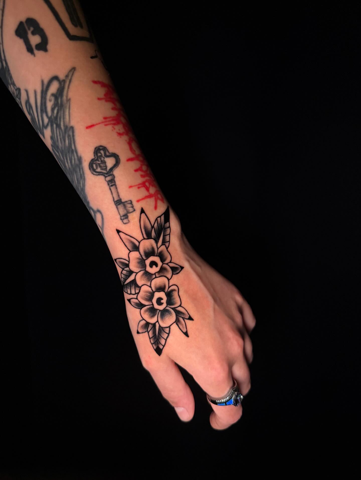 Flowers American traditional tattoo on the hand by Brooke Kresco