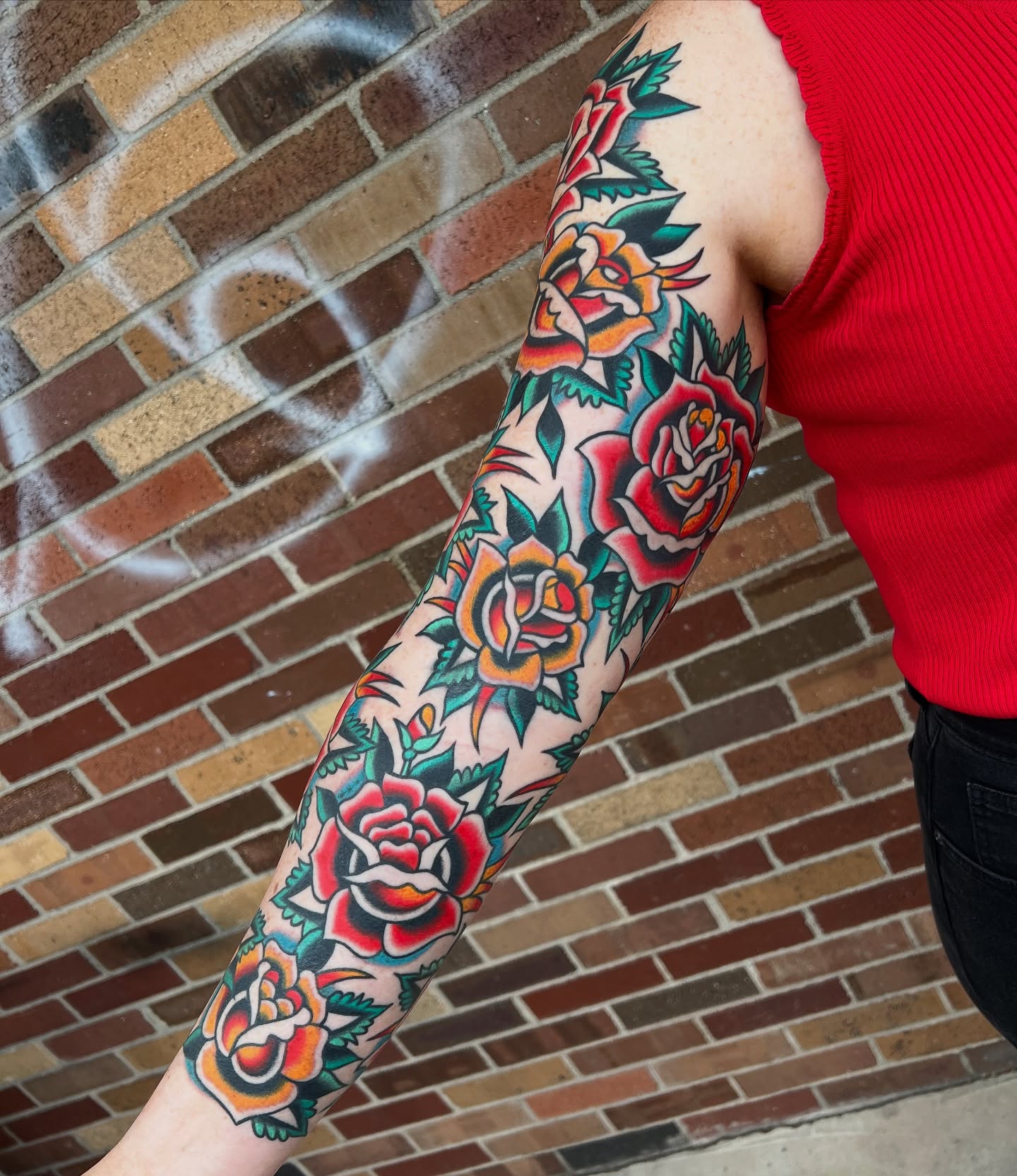 Roses American traditional tattoo on the forearm by Nick Judkins Tattoo